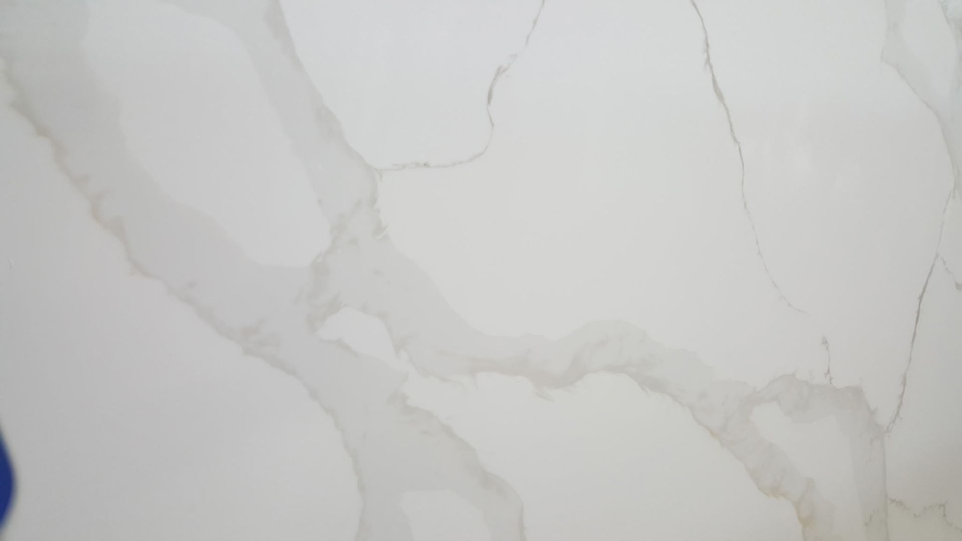 white marble surface with light gray veining and crack lines