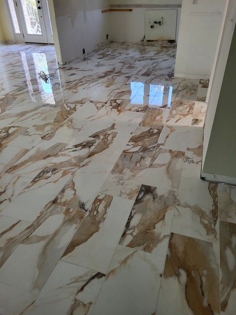 polished marble floor with beige, white, and brown veining in a room