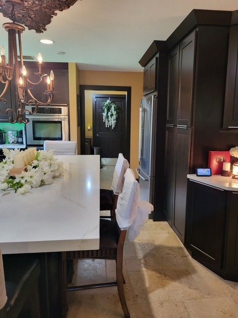 kitchen with dark cabinets, white countertops, and a view of a doorway
