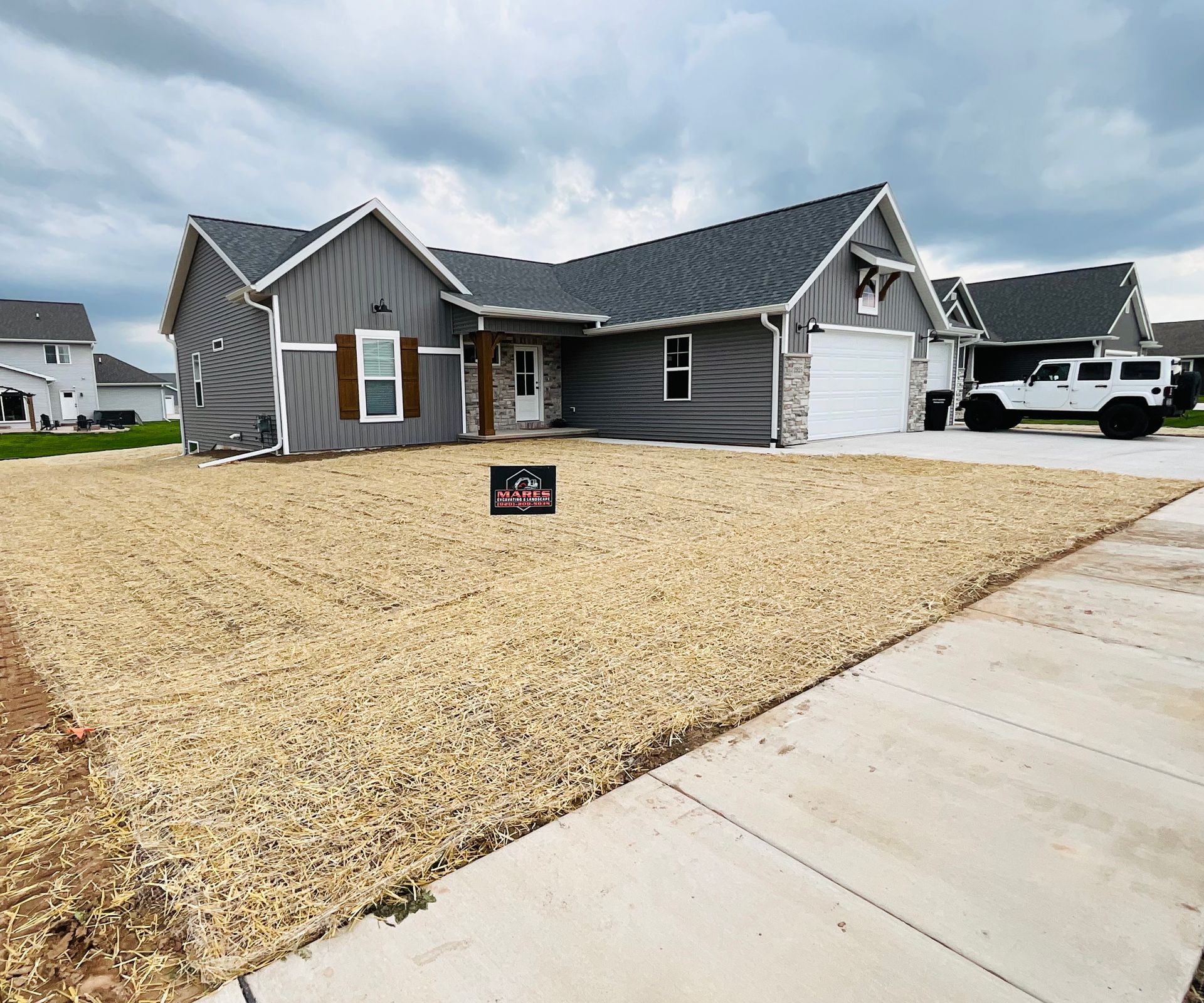 A large house with a lot of gravel in front of it.
