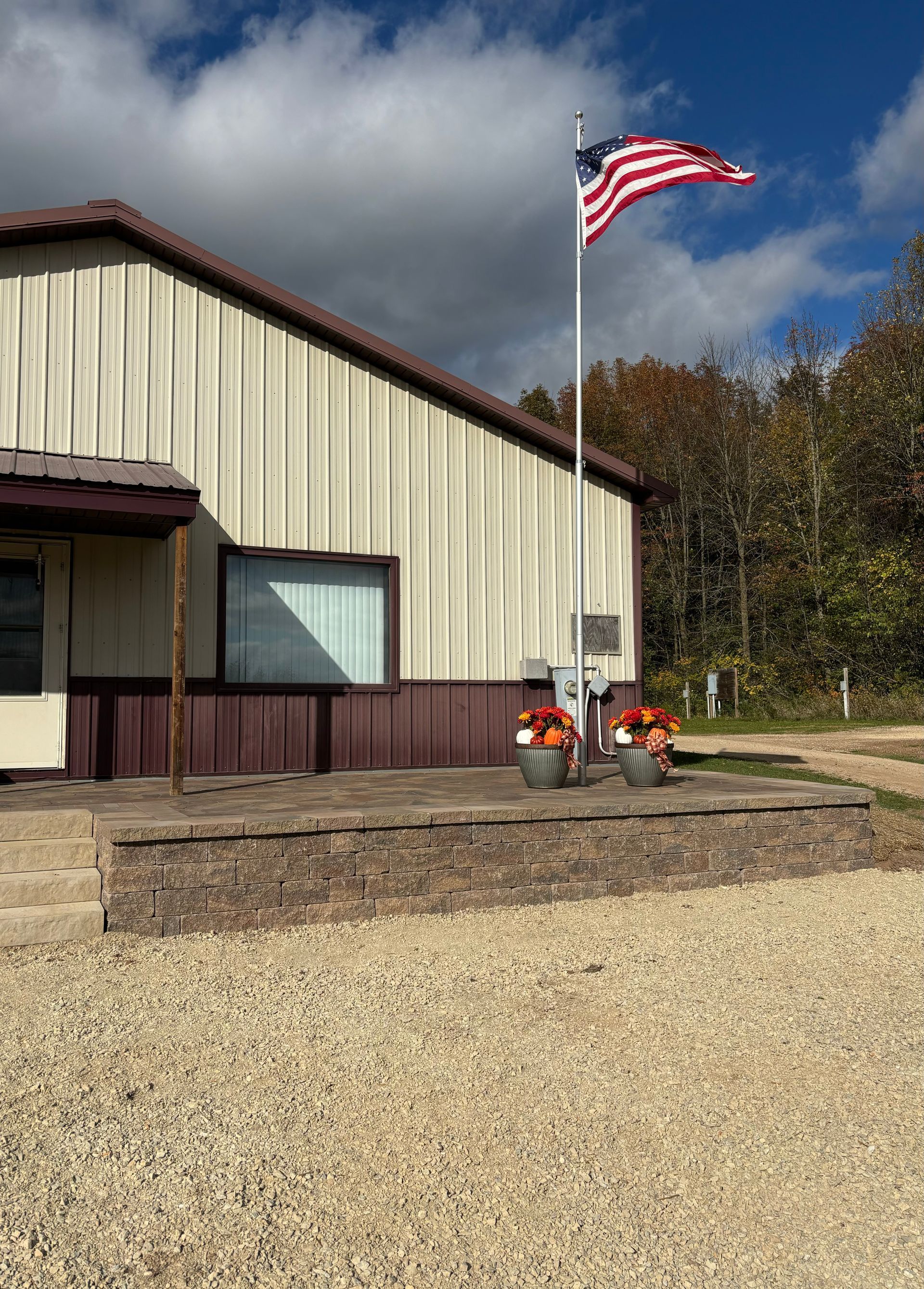 An american flag is flying in front of a building.
