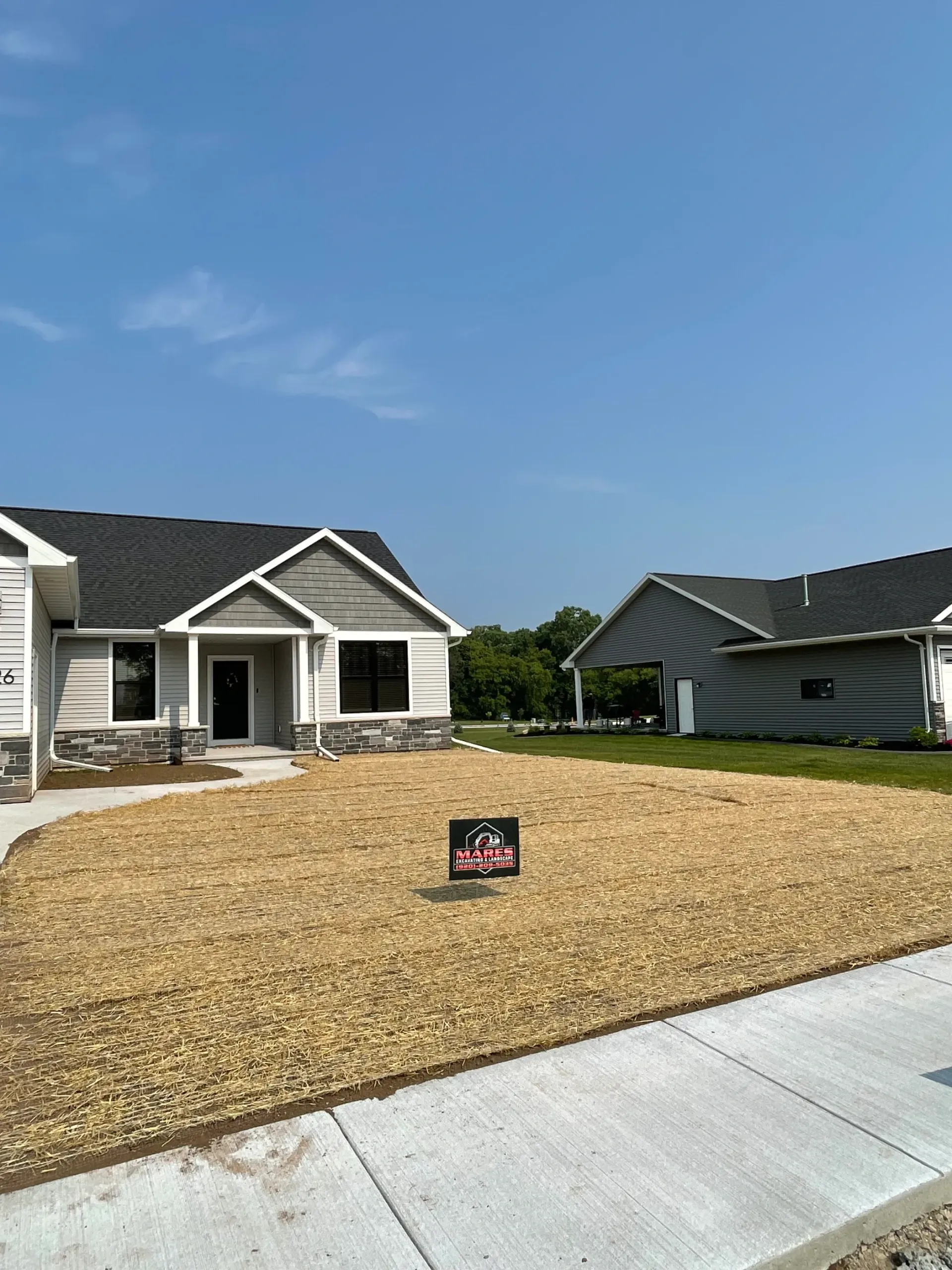 A house with a lot of dirt in front of it.