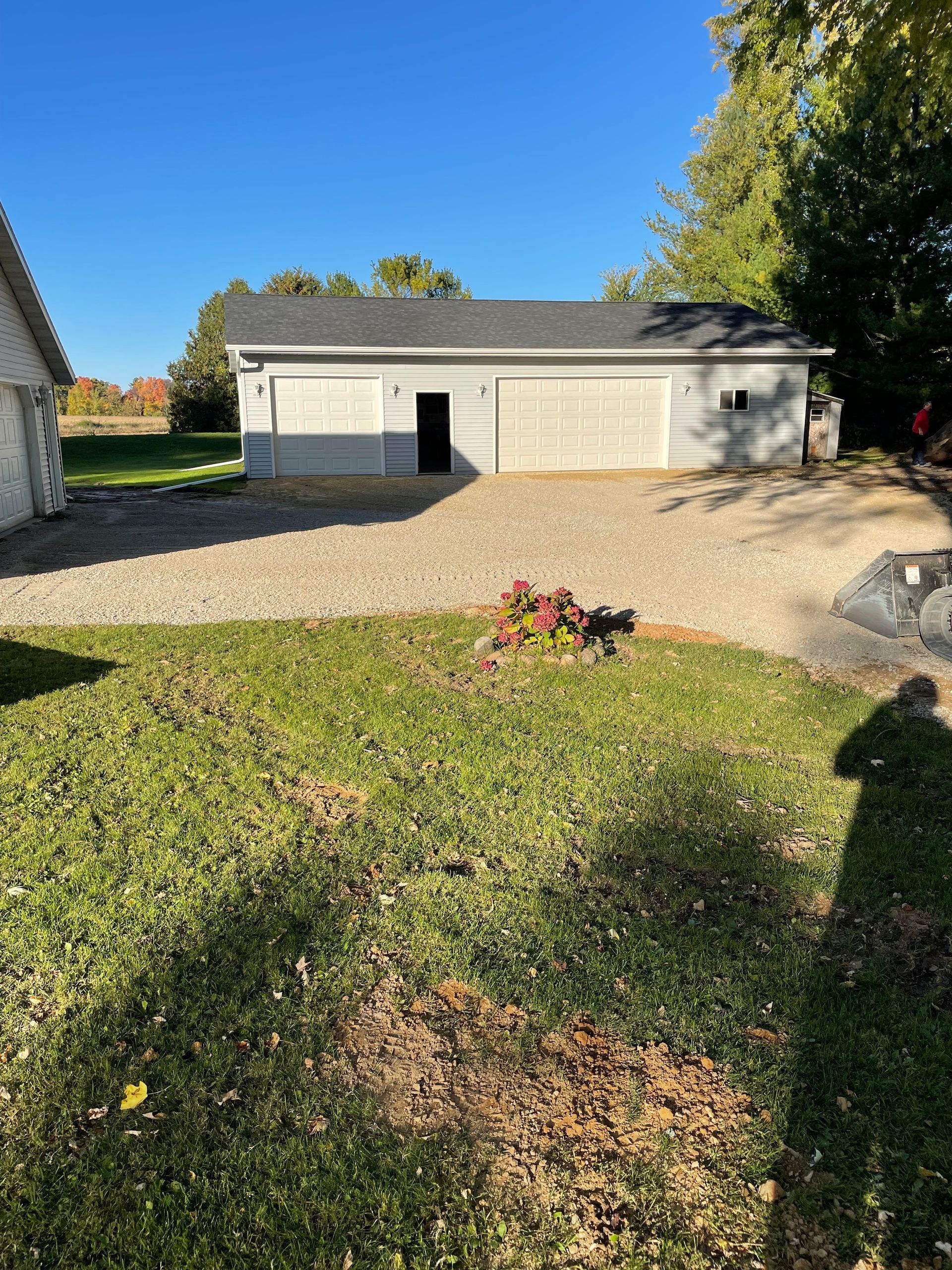 A house with a garage and a driveway in front of it.