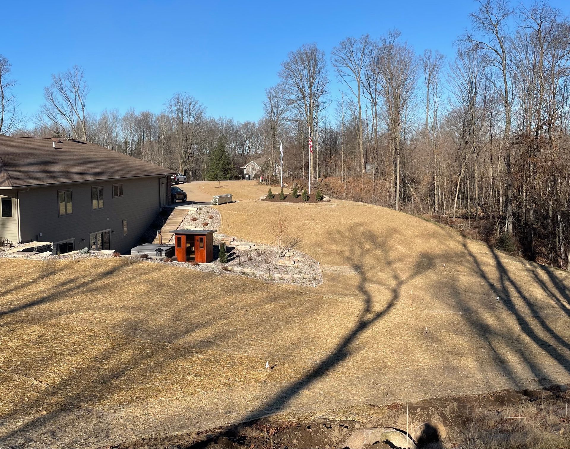 A house in the middle of a field with trees in the background
