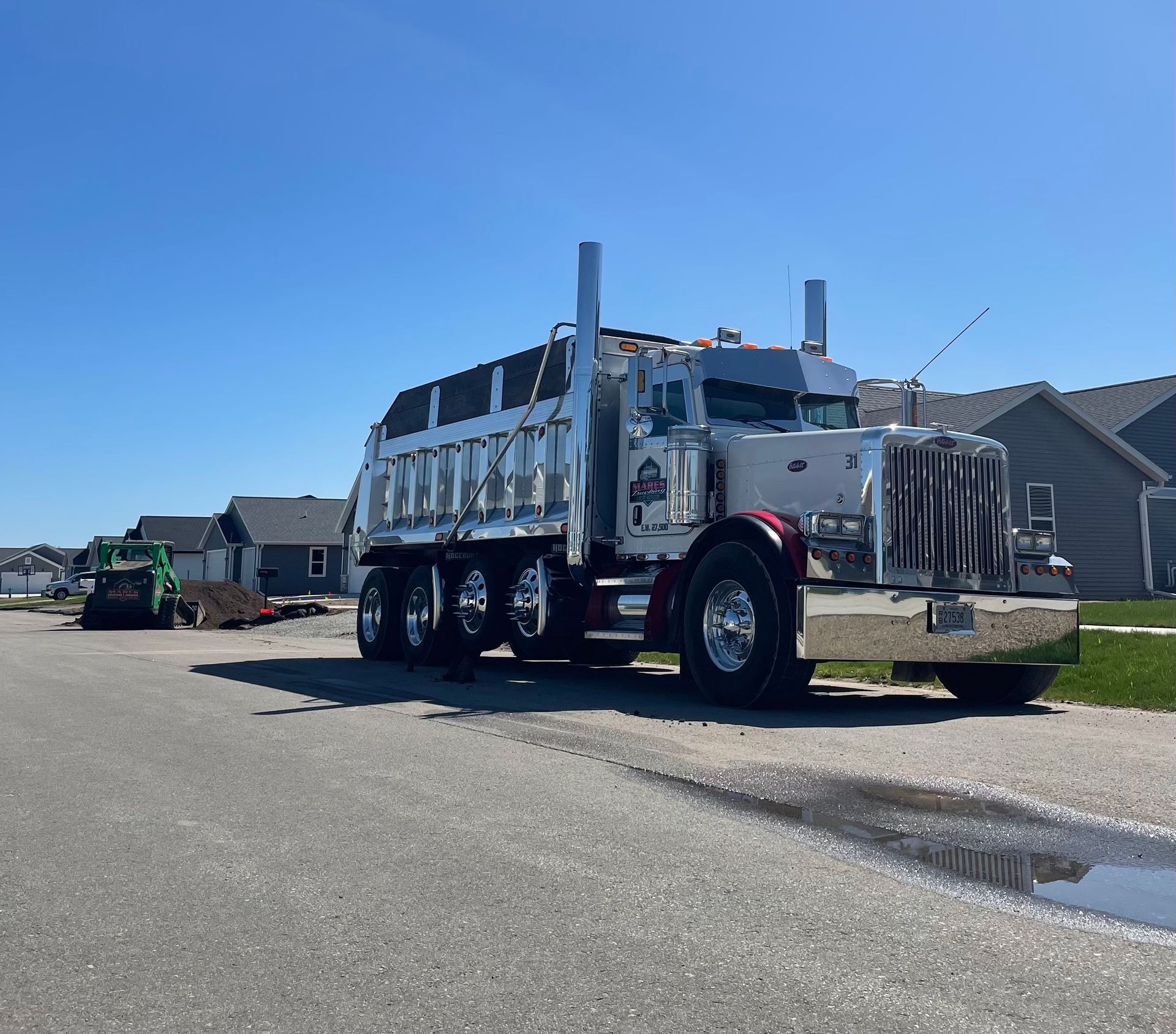 A dump truck is parked on the side of the road
