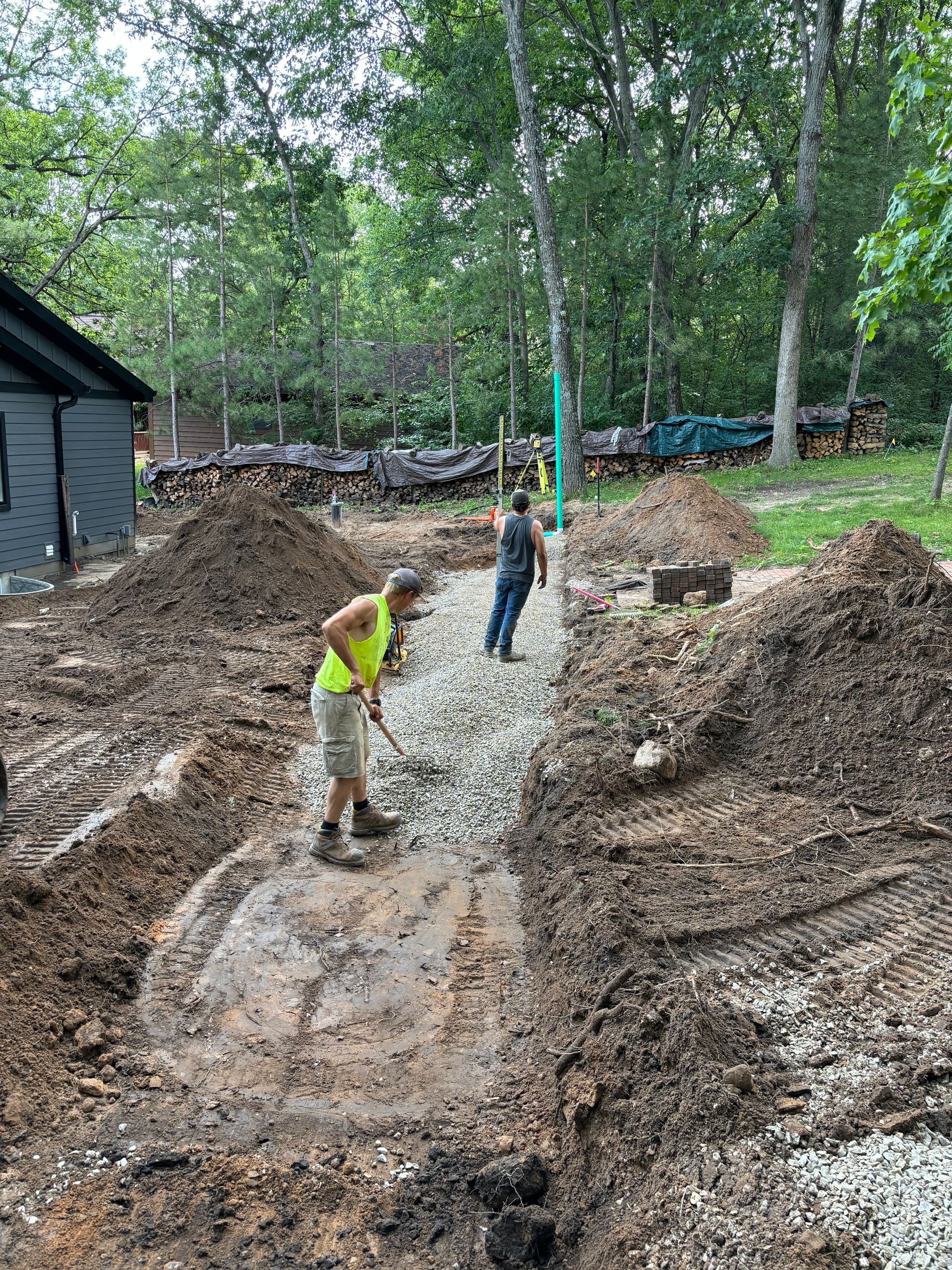 A couple of men are standing in a pile of dirt.