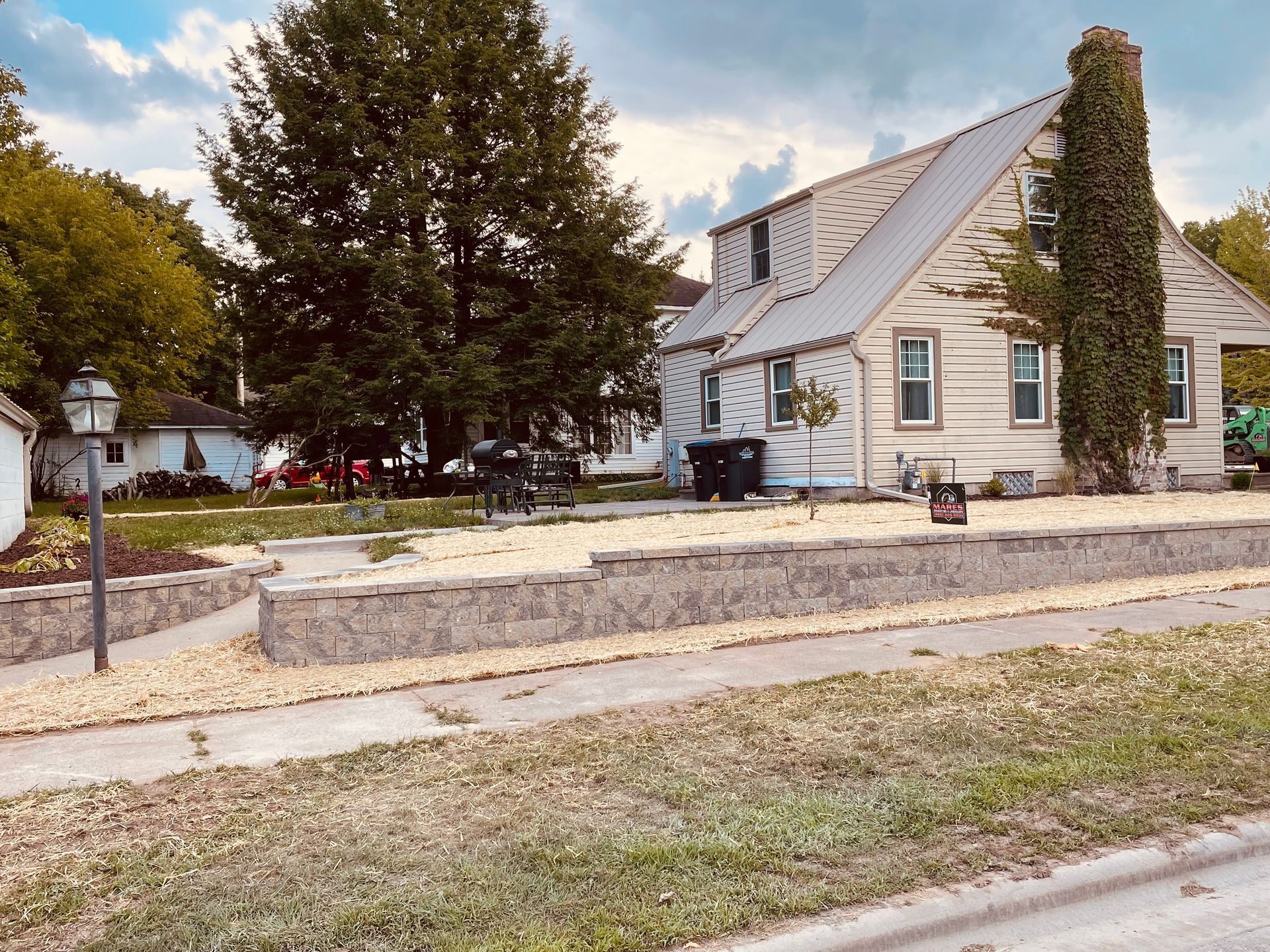 A house with a stone wall in front of it