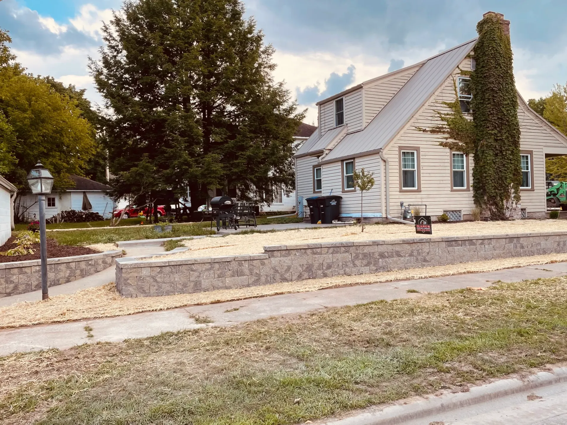 A house with a stone wall in front of it