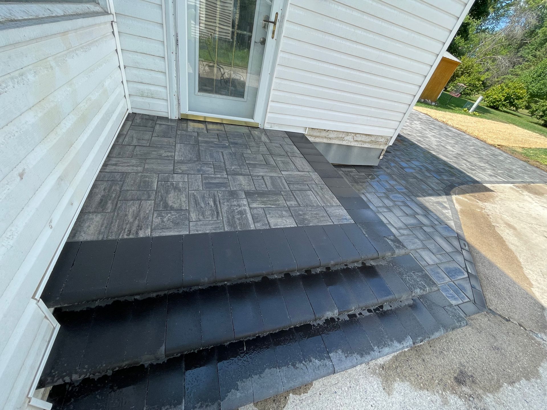 A set of stairs leading up to a doorway of a house.