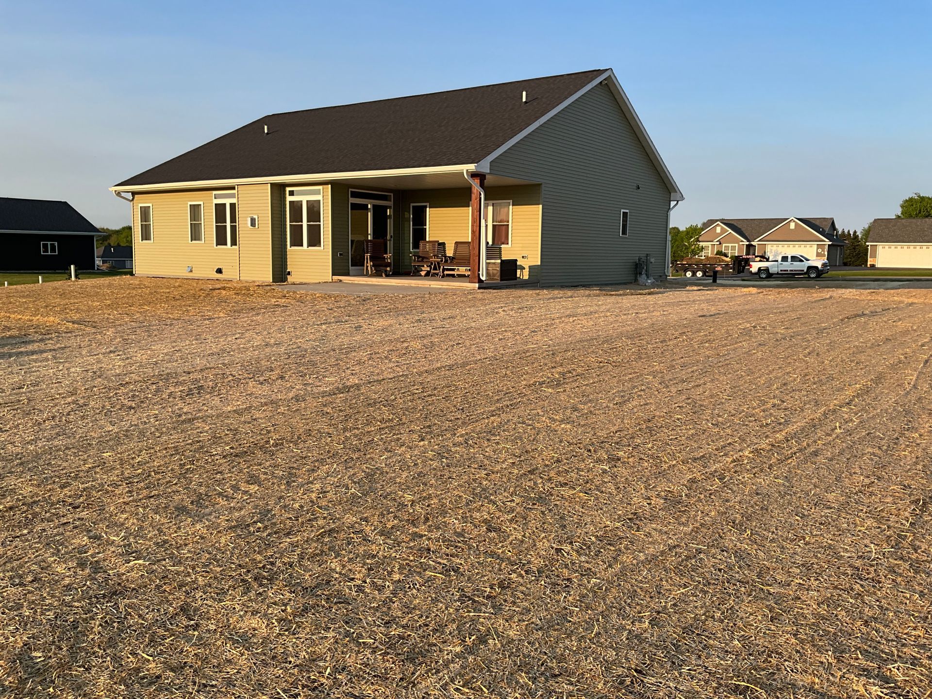 A house is sitting in the middle of a gravel field.