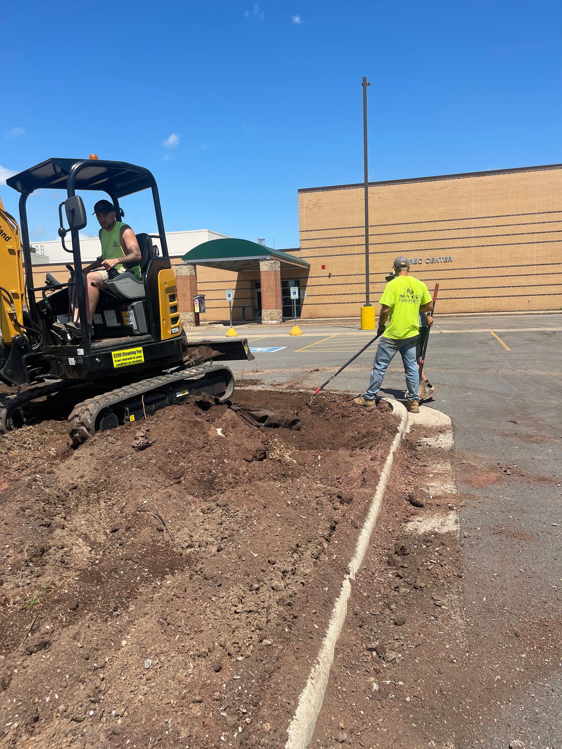 A man is driving a bulldozer in a parking lot
