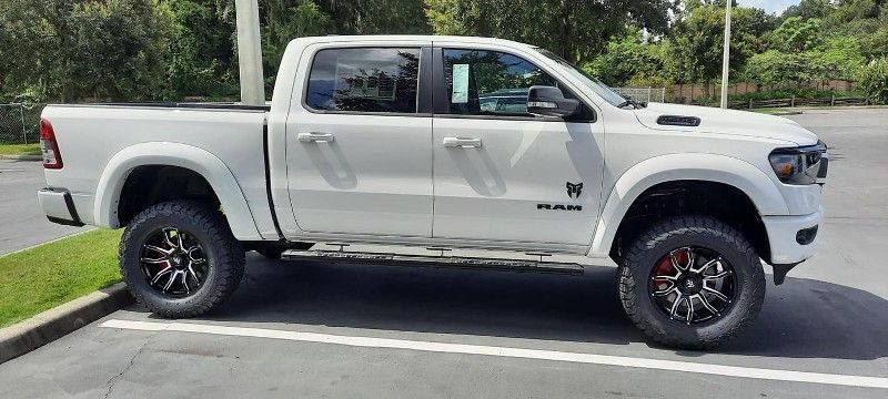 A white truck is parked in a parking lot.