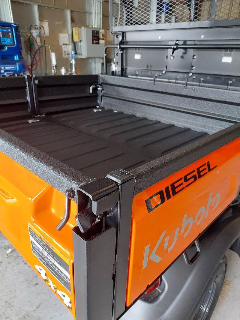 A diesel kubota truck is parked in a garage