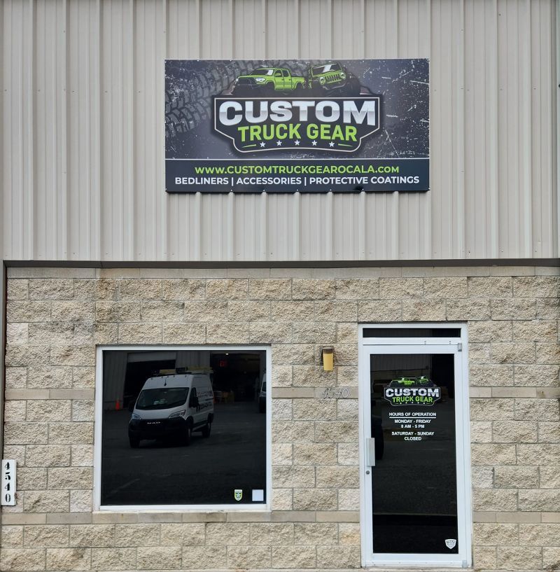 A building with a sign that says custom truck gear