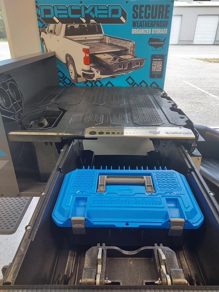 A blue toolbox is sitting in the back of a truck.