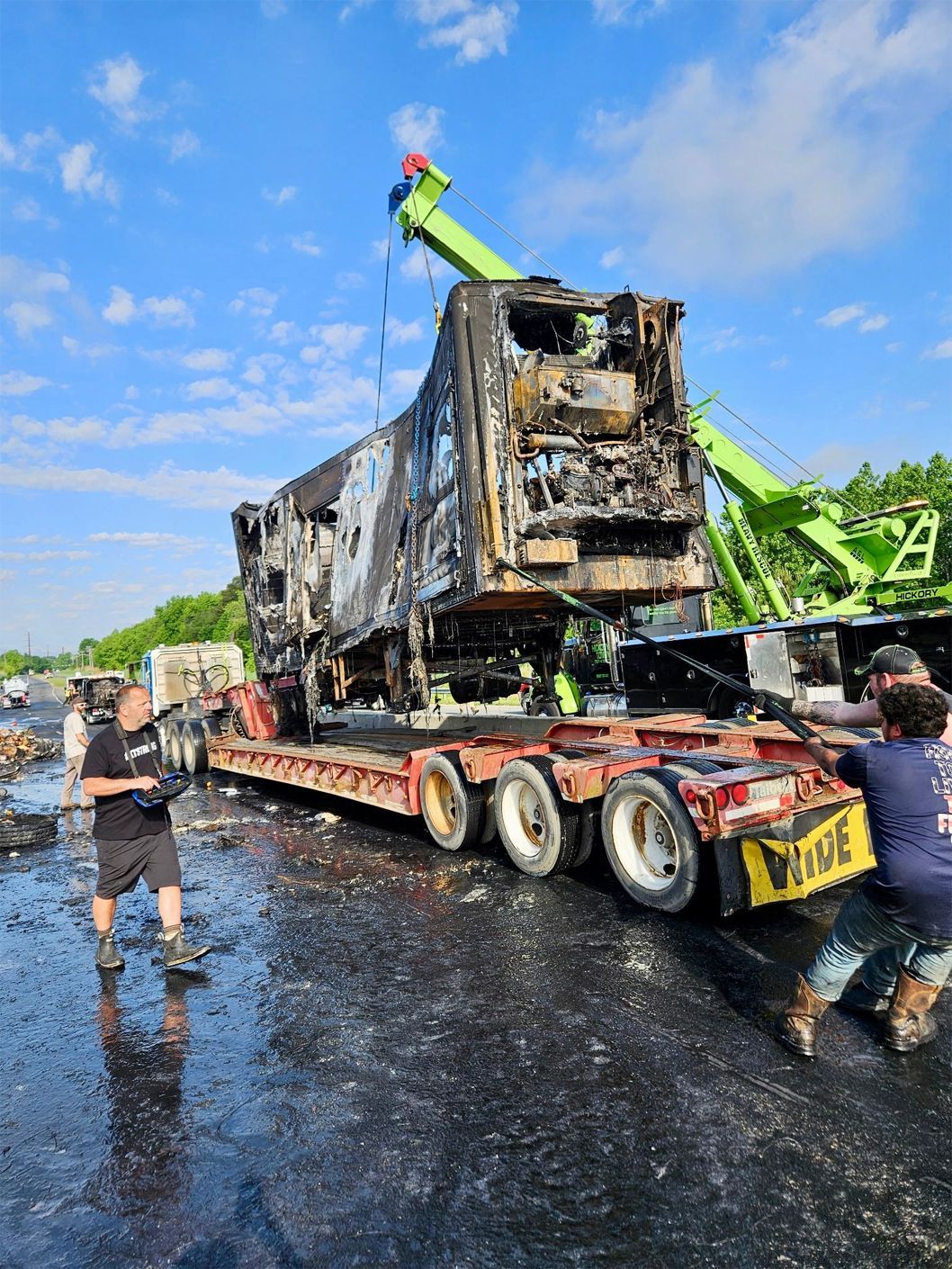 A man is pushing a truck with a crane attached to it.