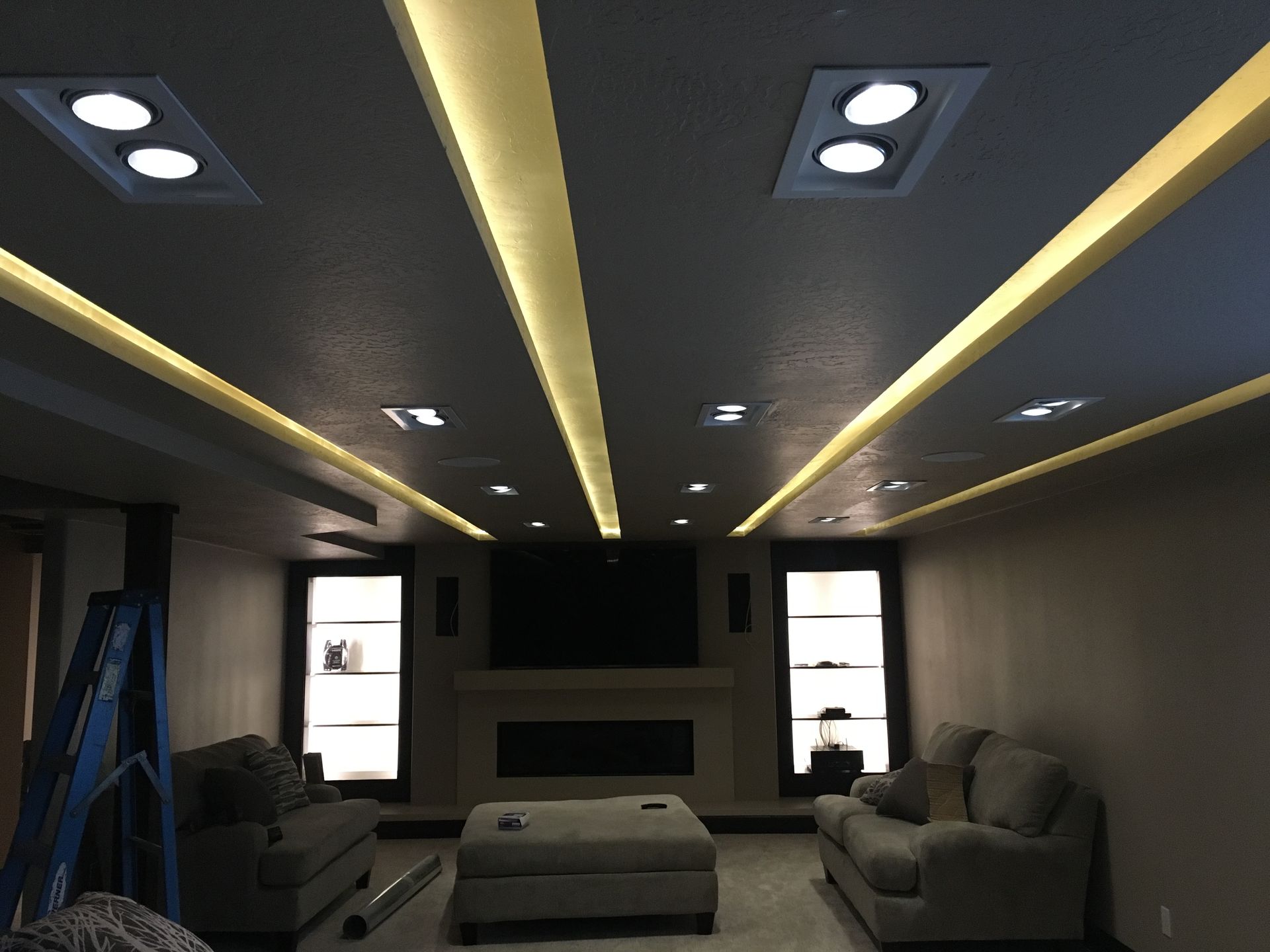 A living room with a couch ottoman and fireplace