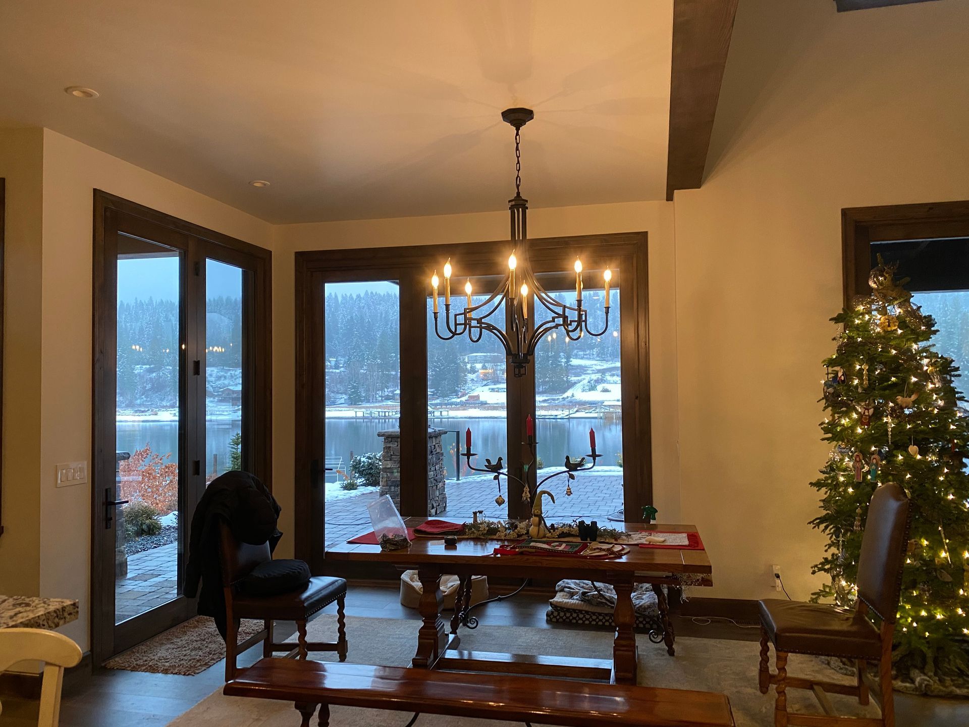 A dining room with a table and chairs and a christmas tree