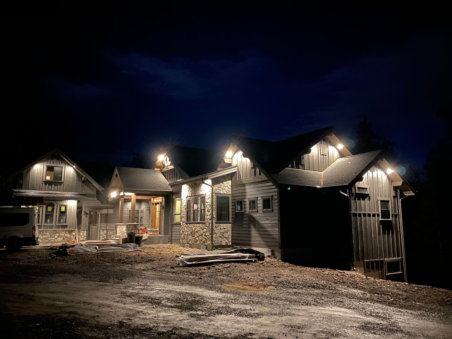 A row of houses are lit up at night.
