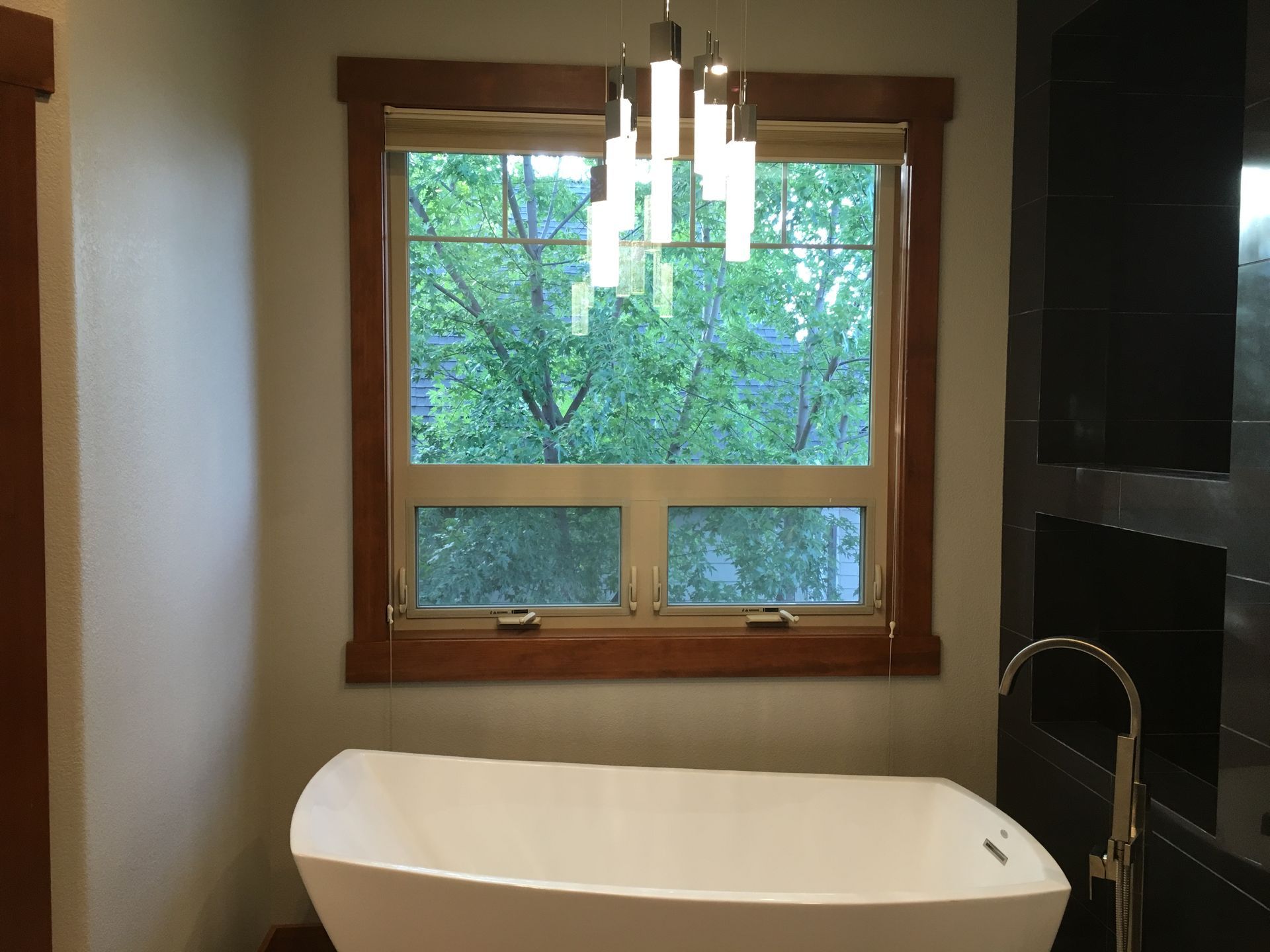 A bathroom with a bathtub and a window.