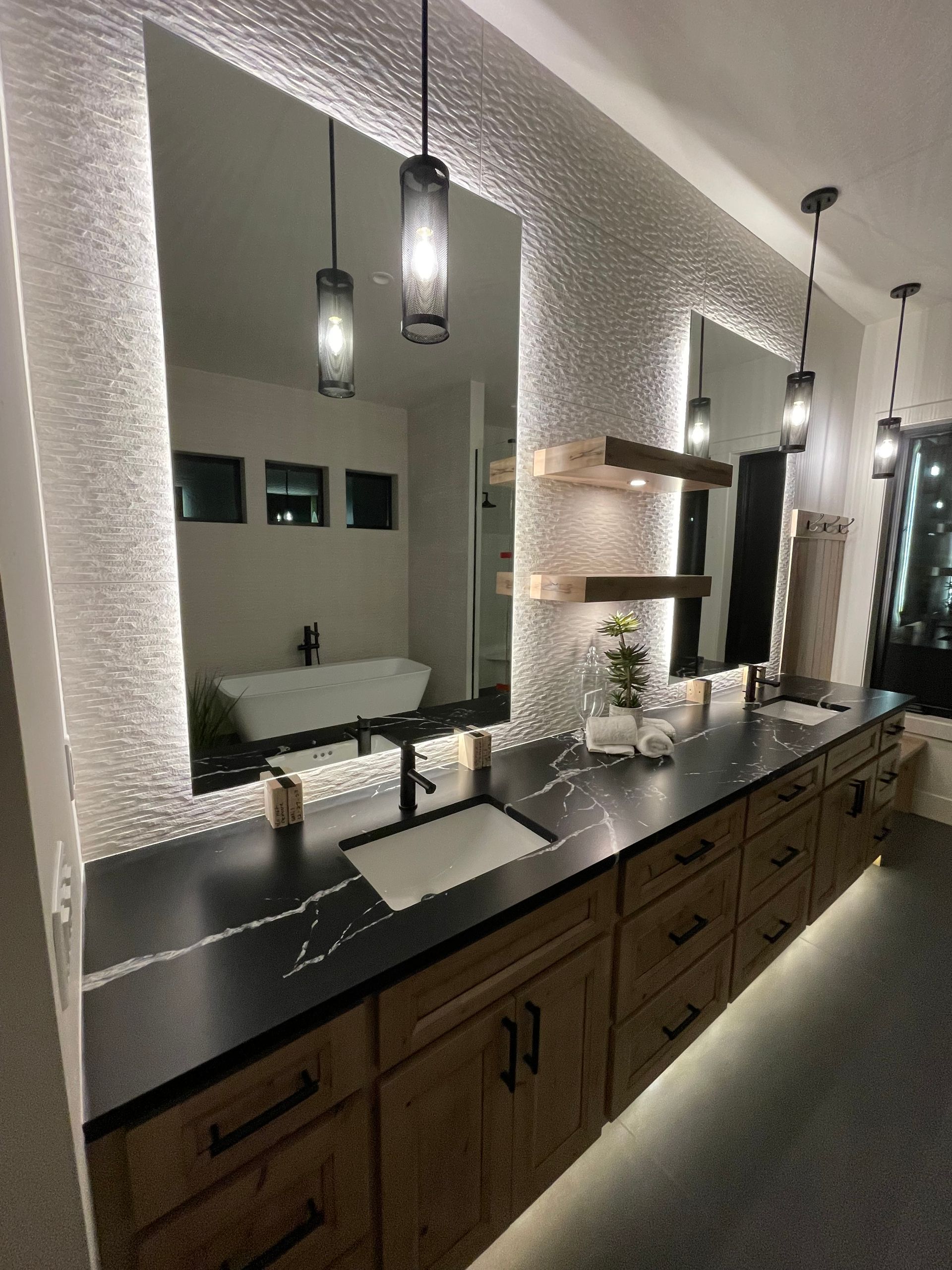 A bathroom with two sinks and a large mirror