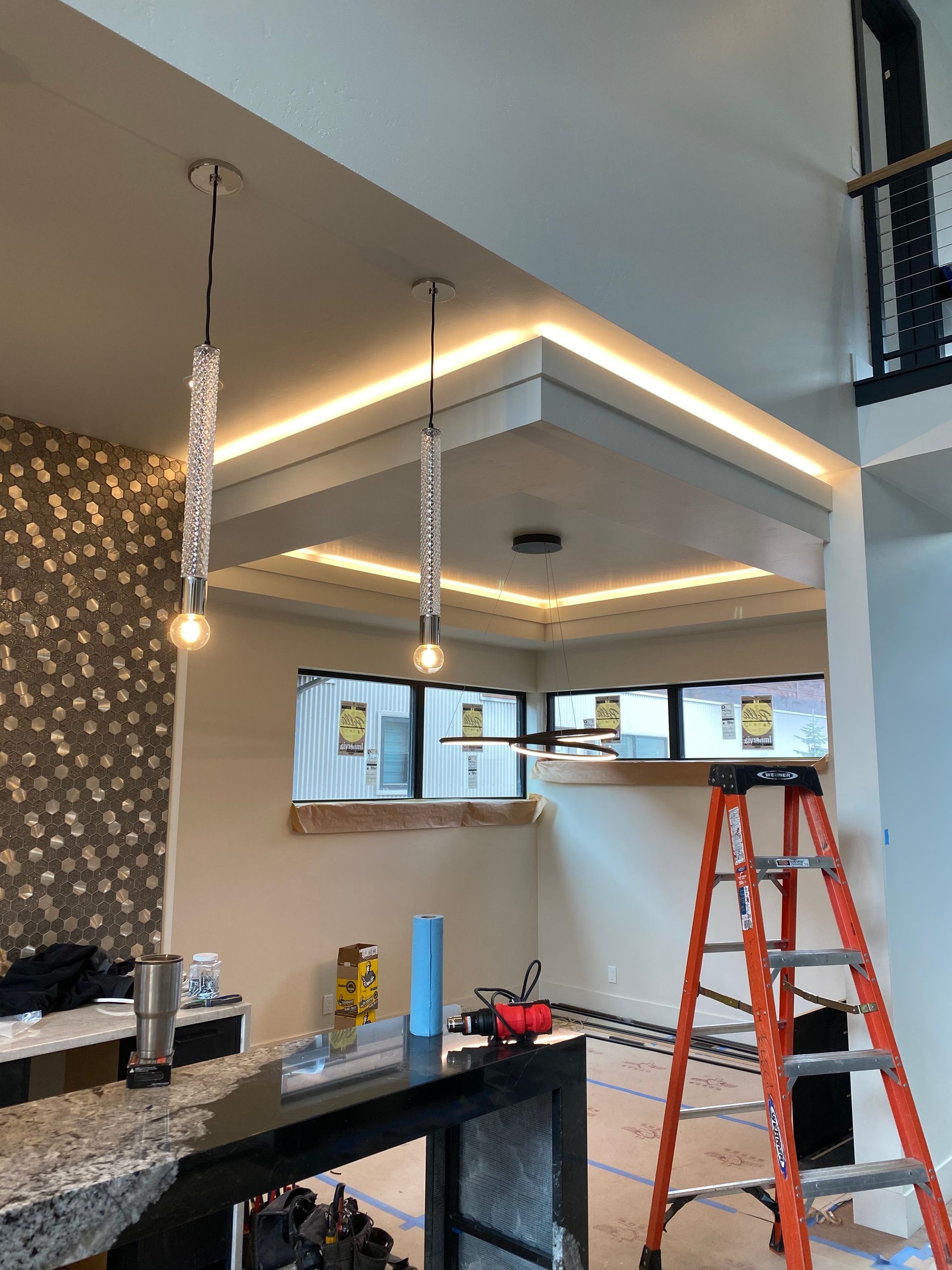 A kitchen under construction with a ladder in the foreground.