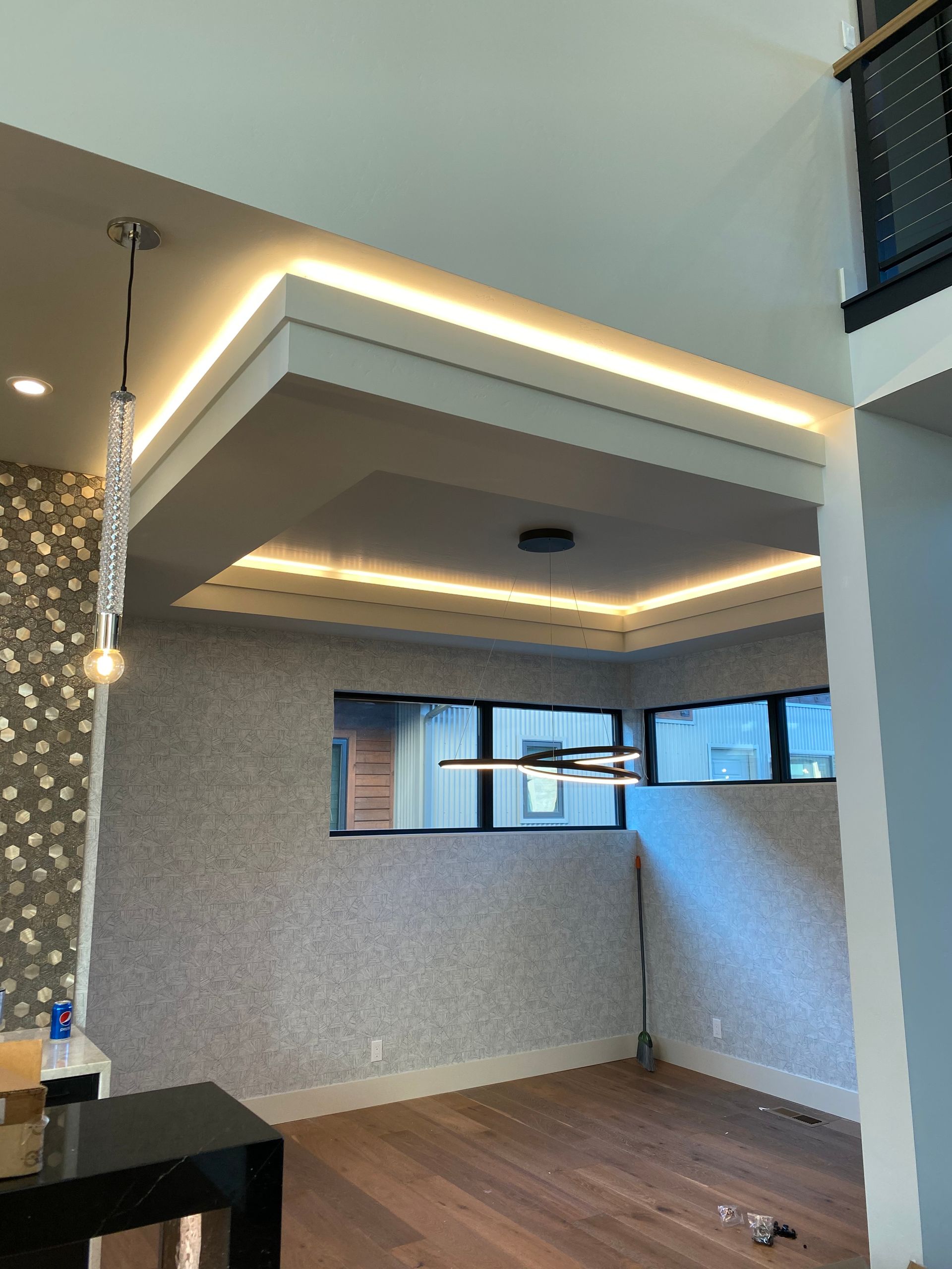 A living room with a ceiling fan and lights on it
