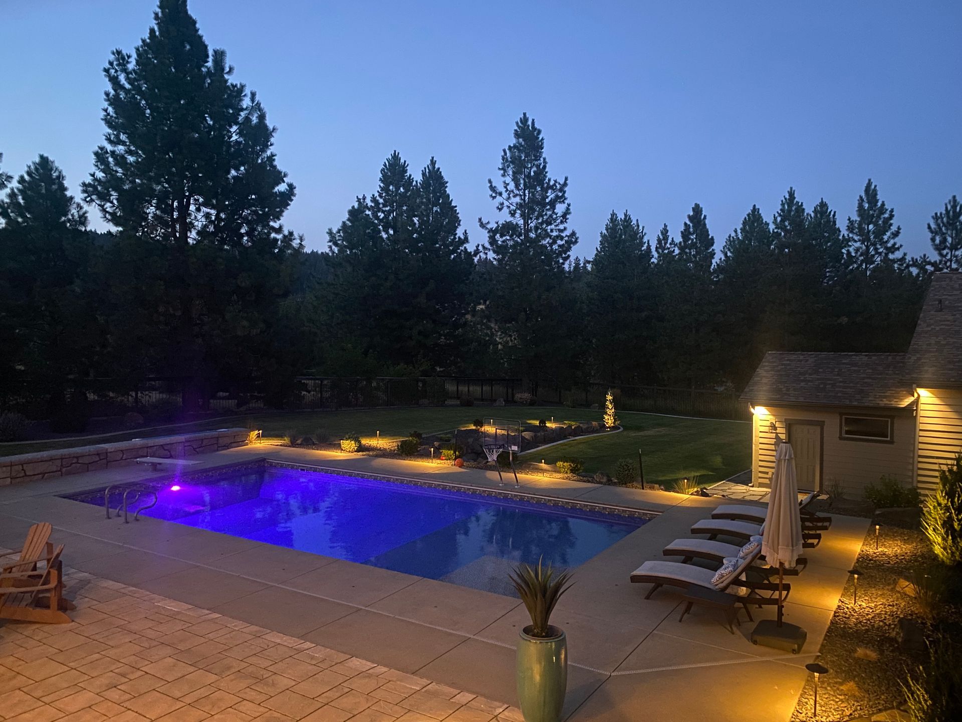 A large swimming pool is lit up at night