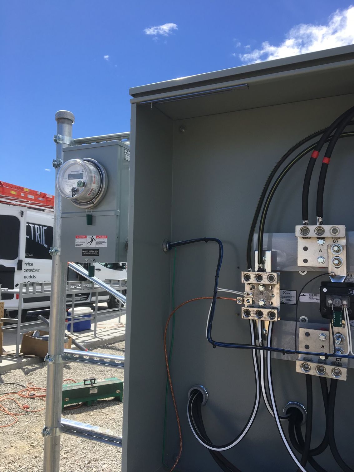 A close up of a electrical box with wires coming out of it.