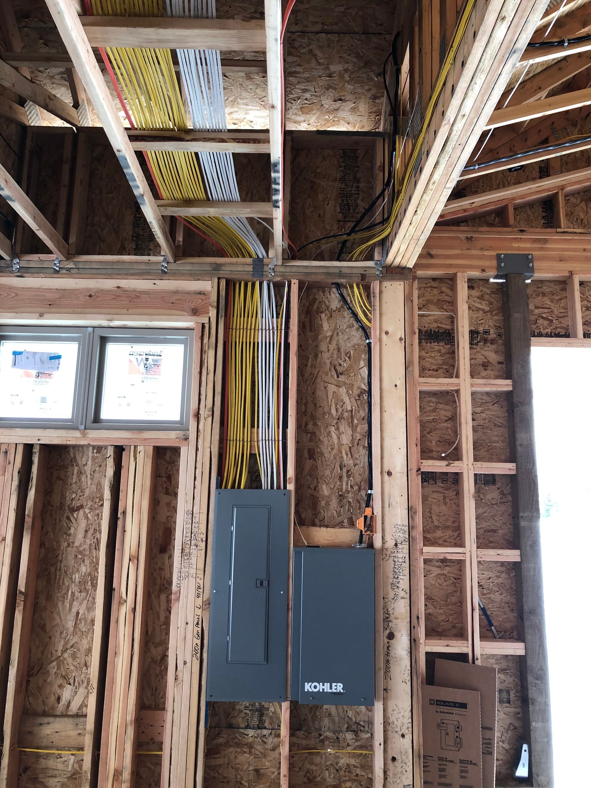 A building under construction with a lot of wires hanging from the ceiling.
