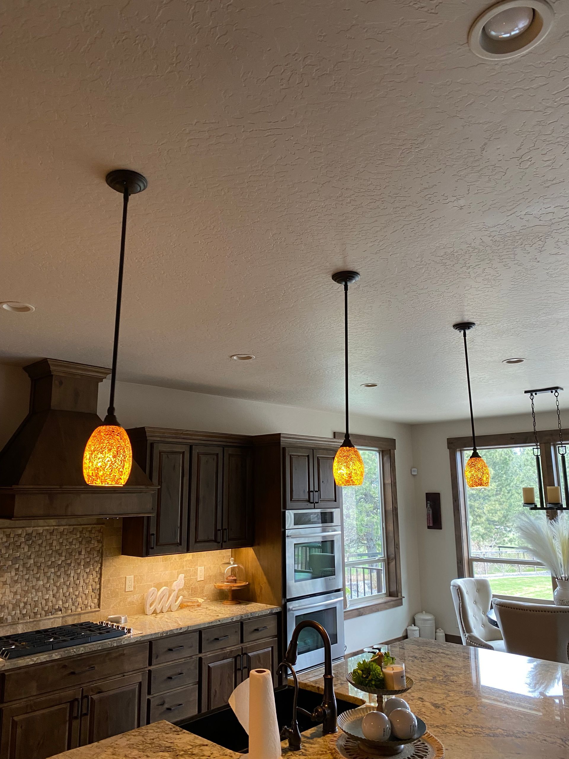 A kitchen with a stove top oven and a sink