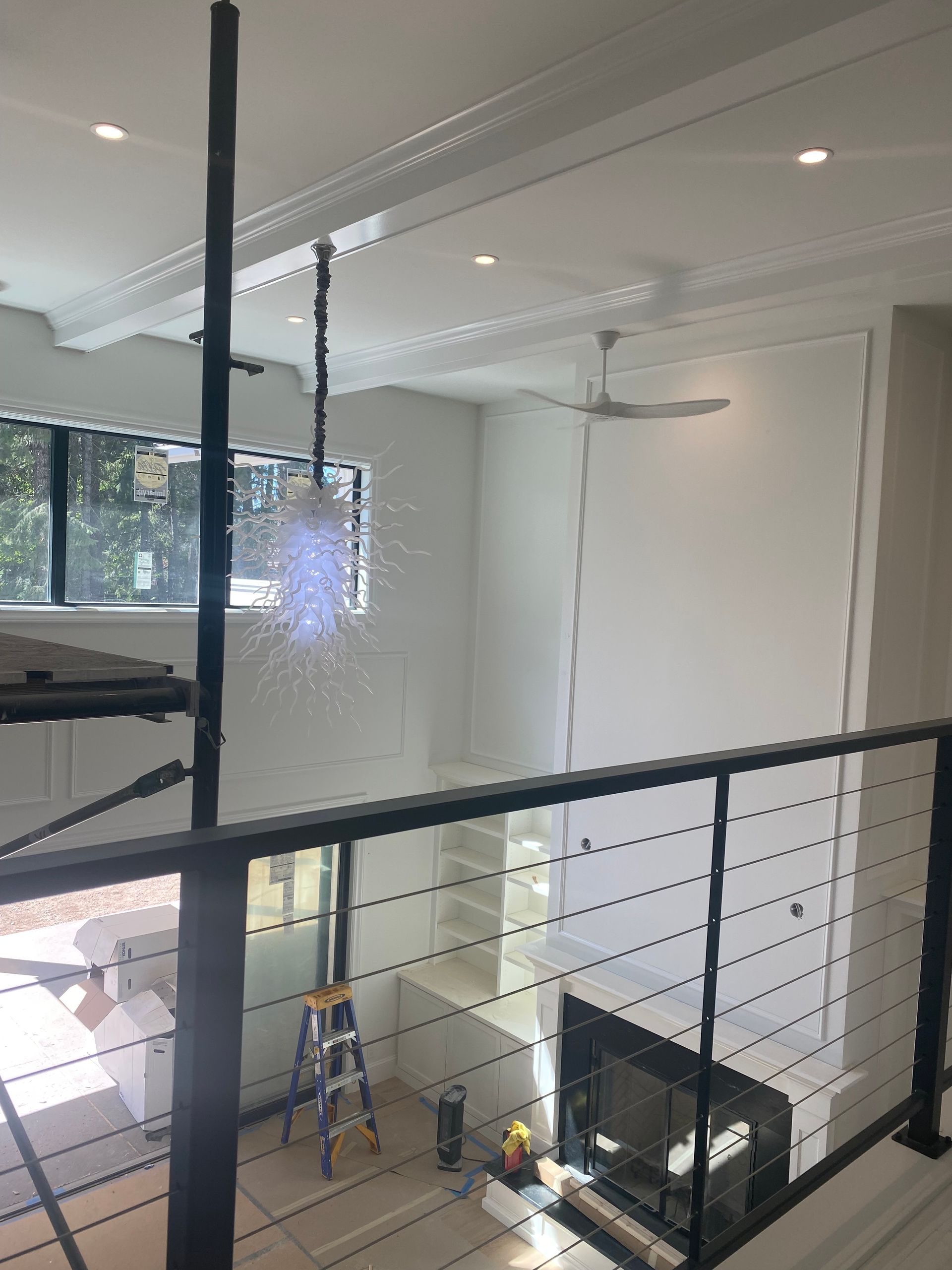 A view of a living room from a balcony with a black railing