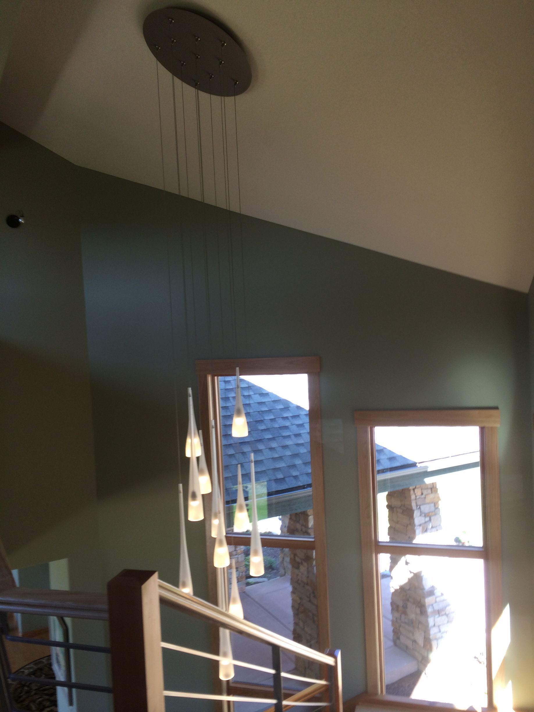 A staircase with a light hanging from the ceiling