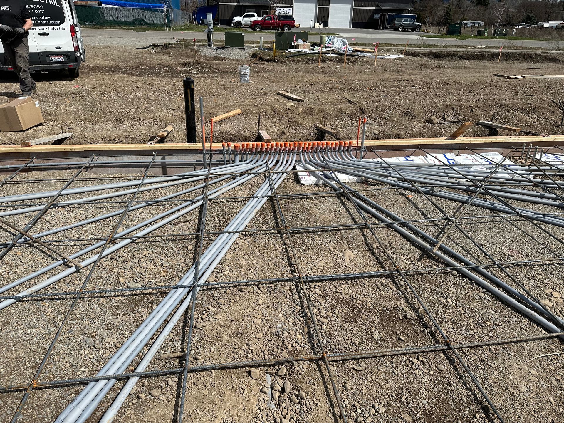 A construction site with a lot of wires laying on the ground.