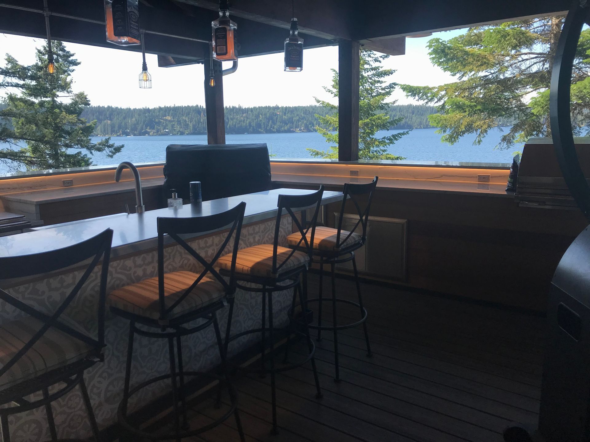 A bar with a view of a lake and trees