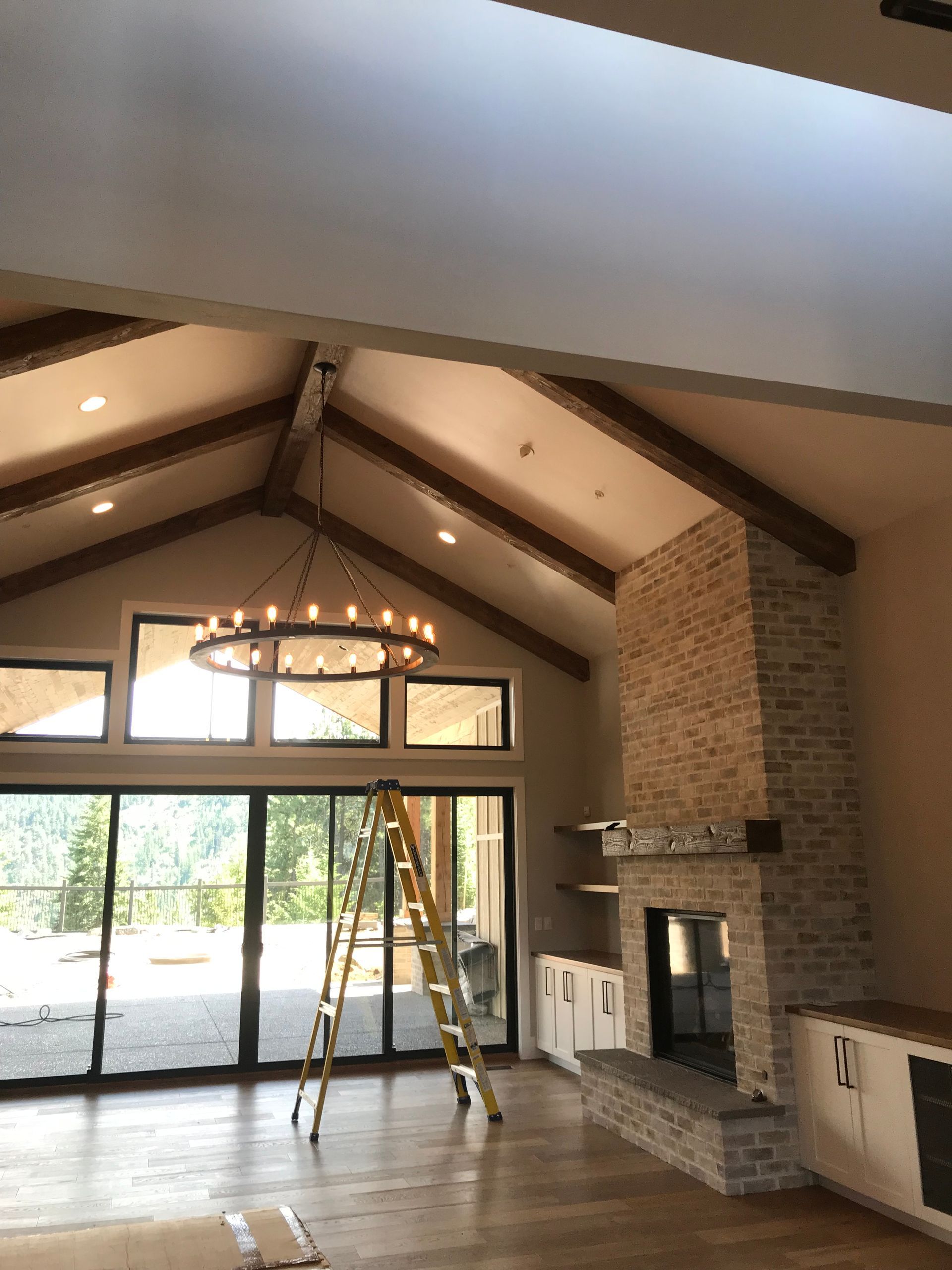 A living room with a fireplace and a chandelier