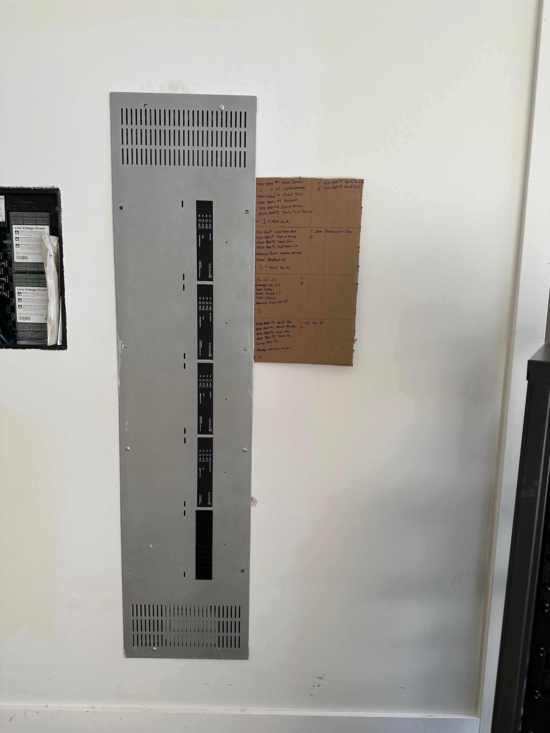 A white wall with a electrical box on it