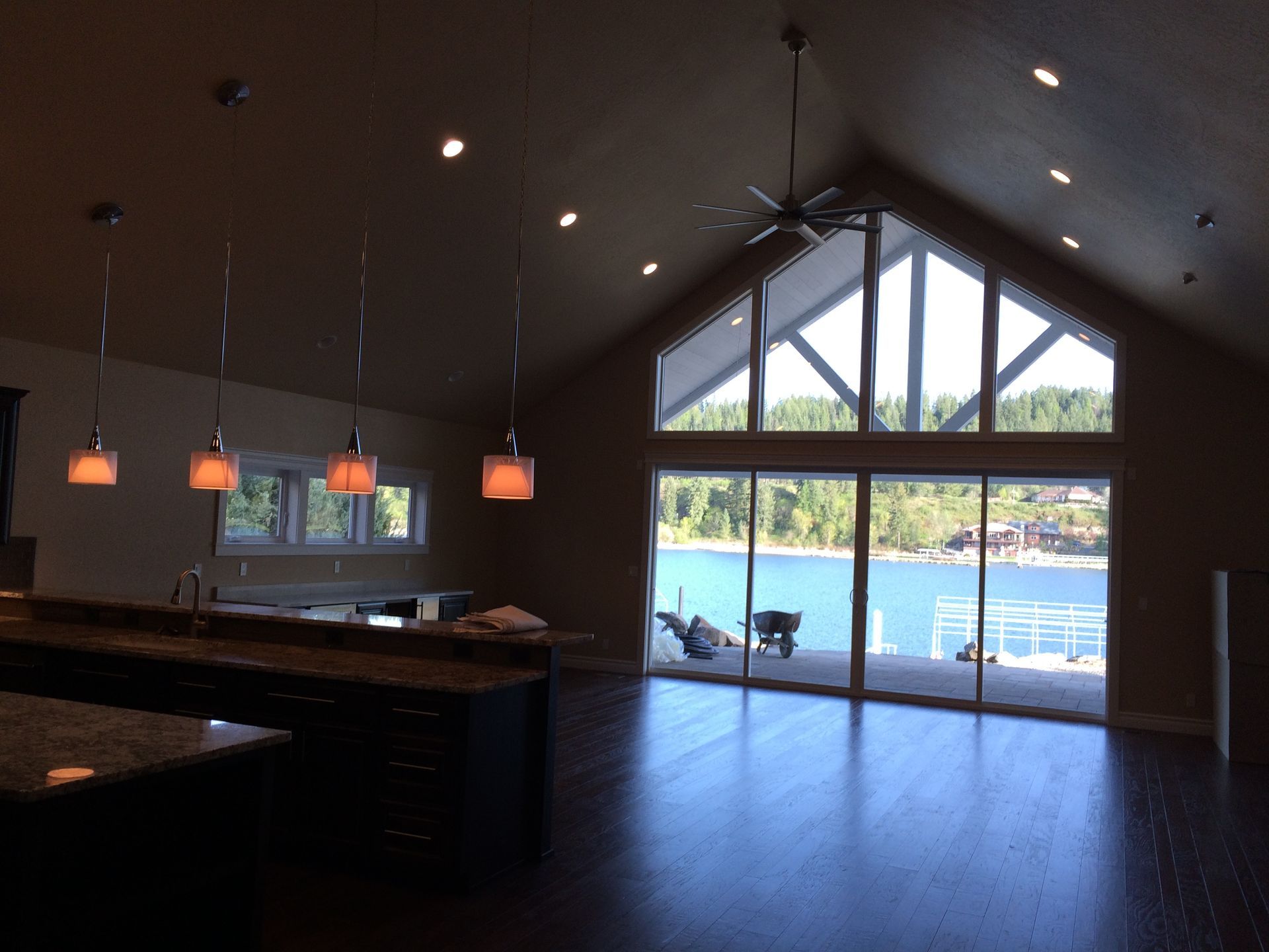 A large room with a lot of windows and a view of a lake