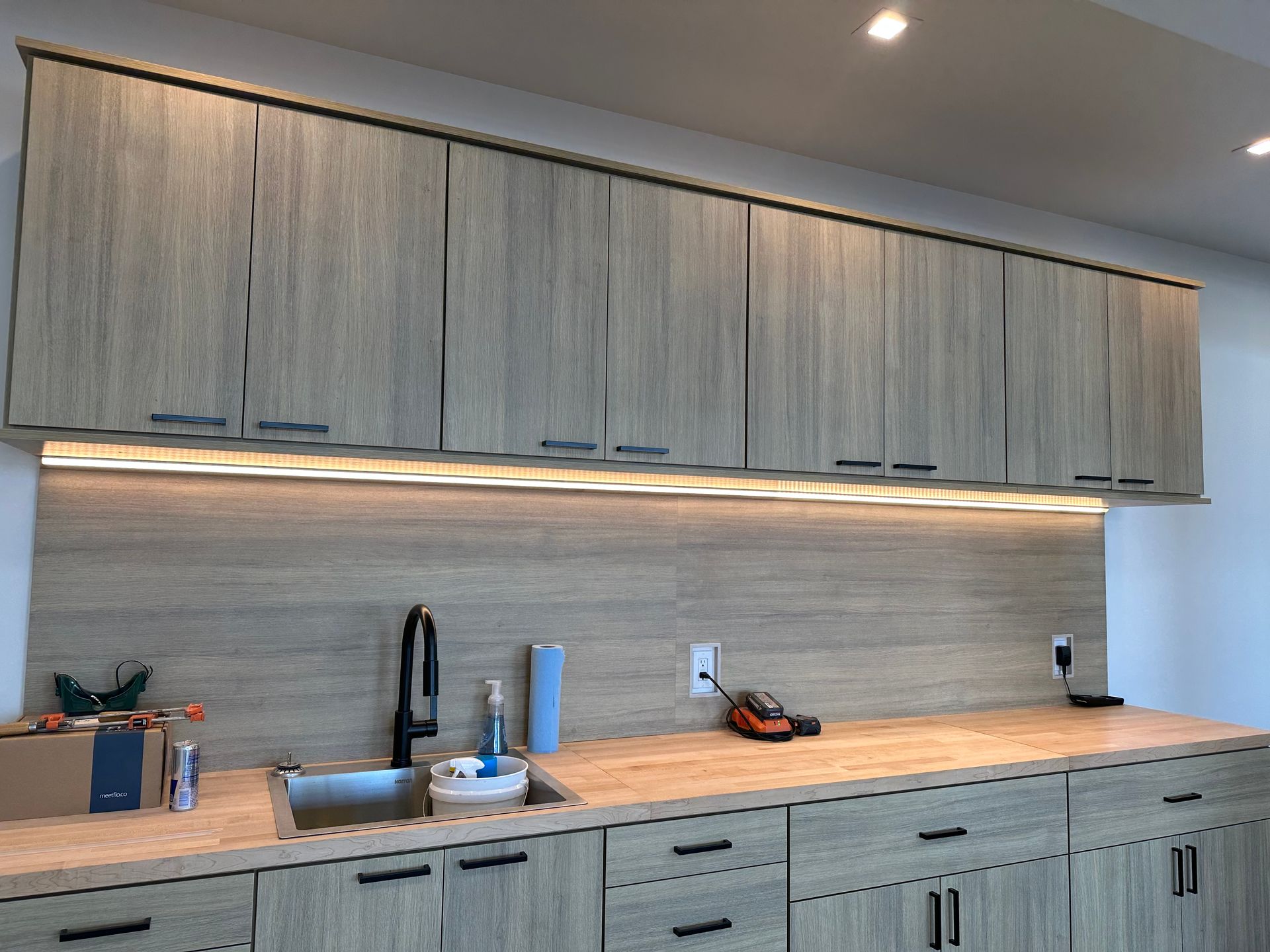 A kitchen with wooden cabinets and a sink.
