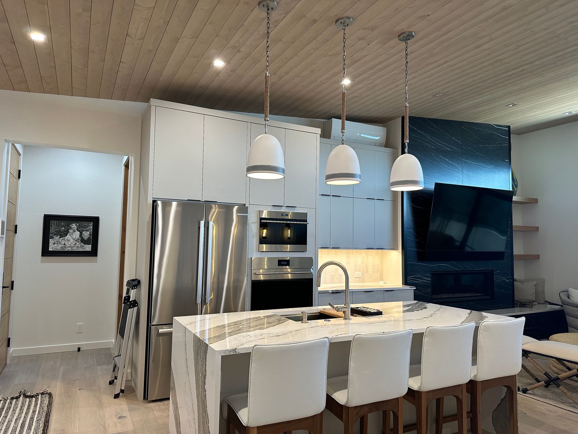A kitchen with stainless steel appliances and white cabinets