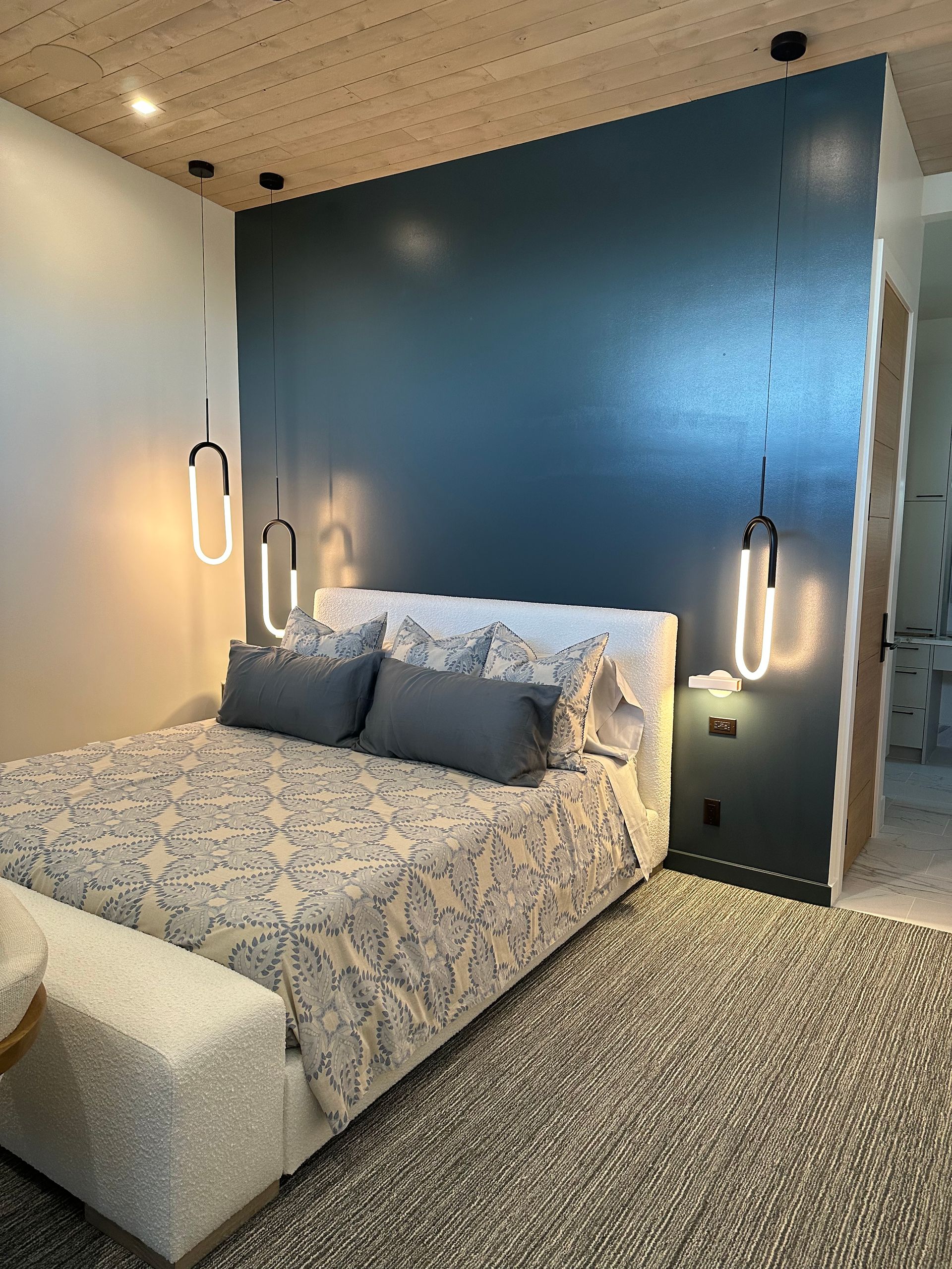 A bedroom with a large bed and a blue wall