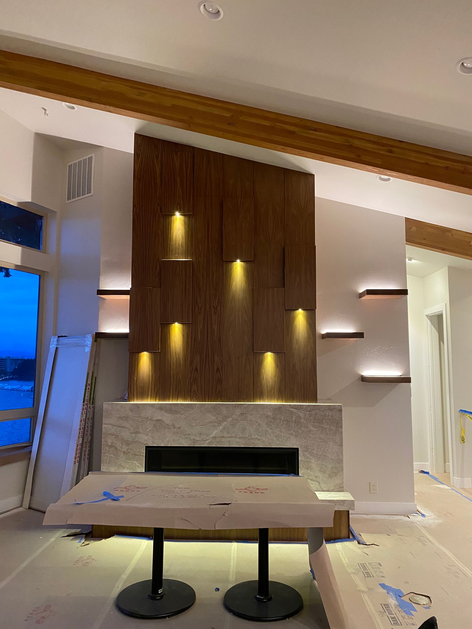 A living room with a fireplace and a table in it.