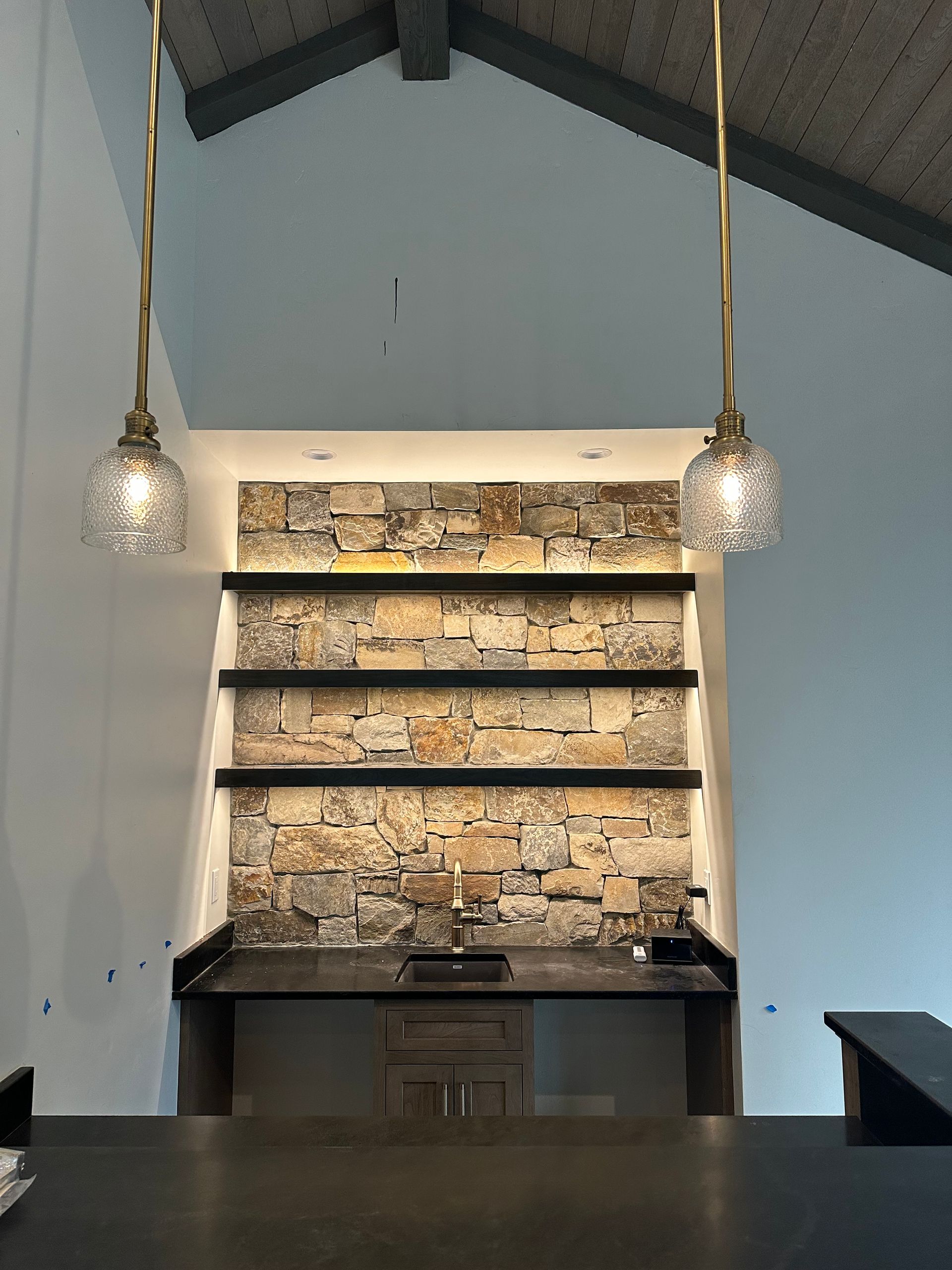 A kitchen with two pendant lights hanging from the ceiling