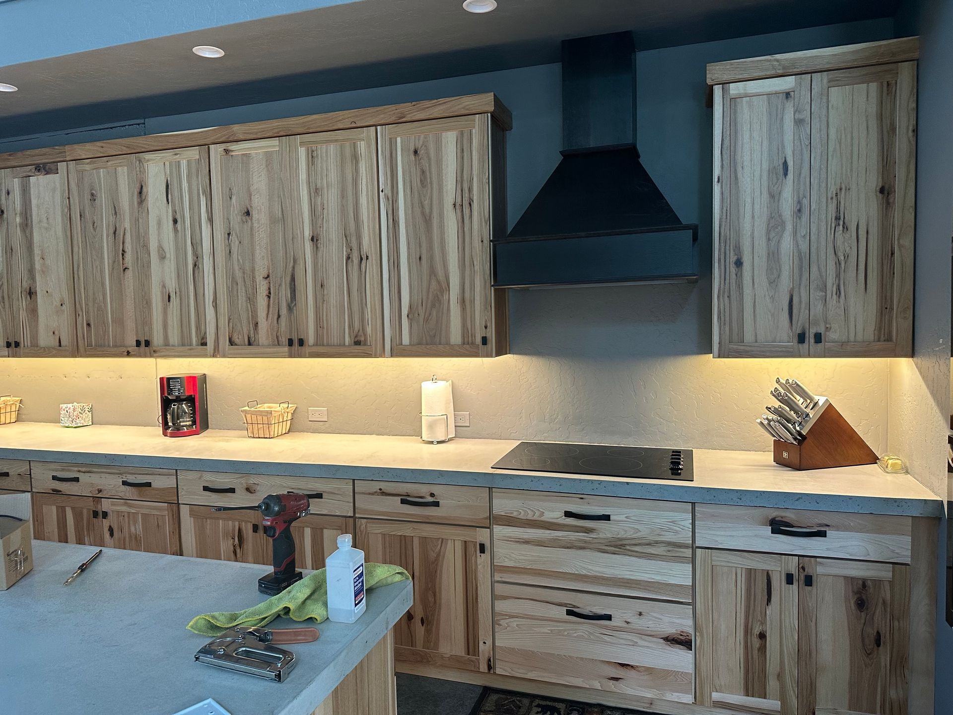A kitchen with wooden cabinets and a stove top oven.