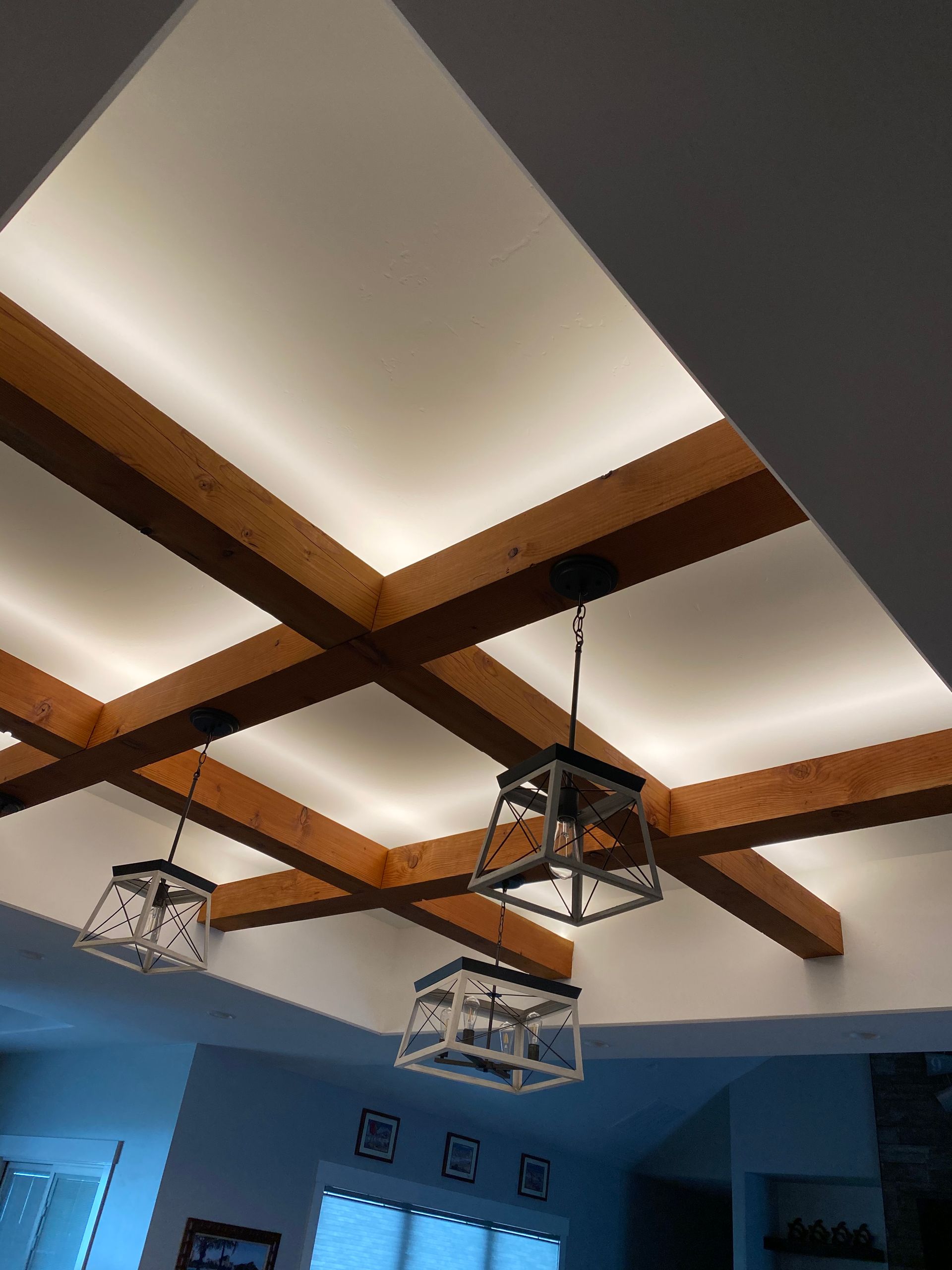 A ceiling with wooden beams and lights hanging from it