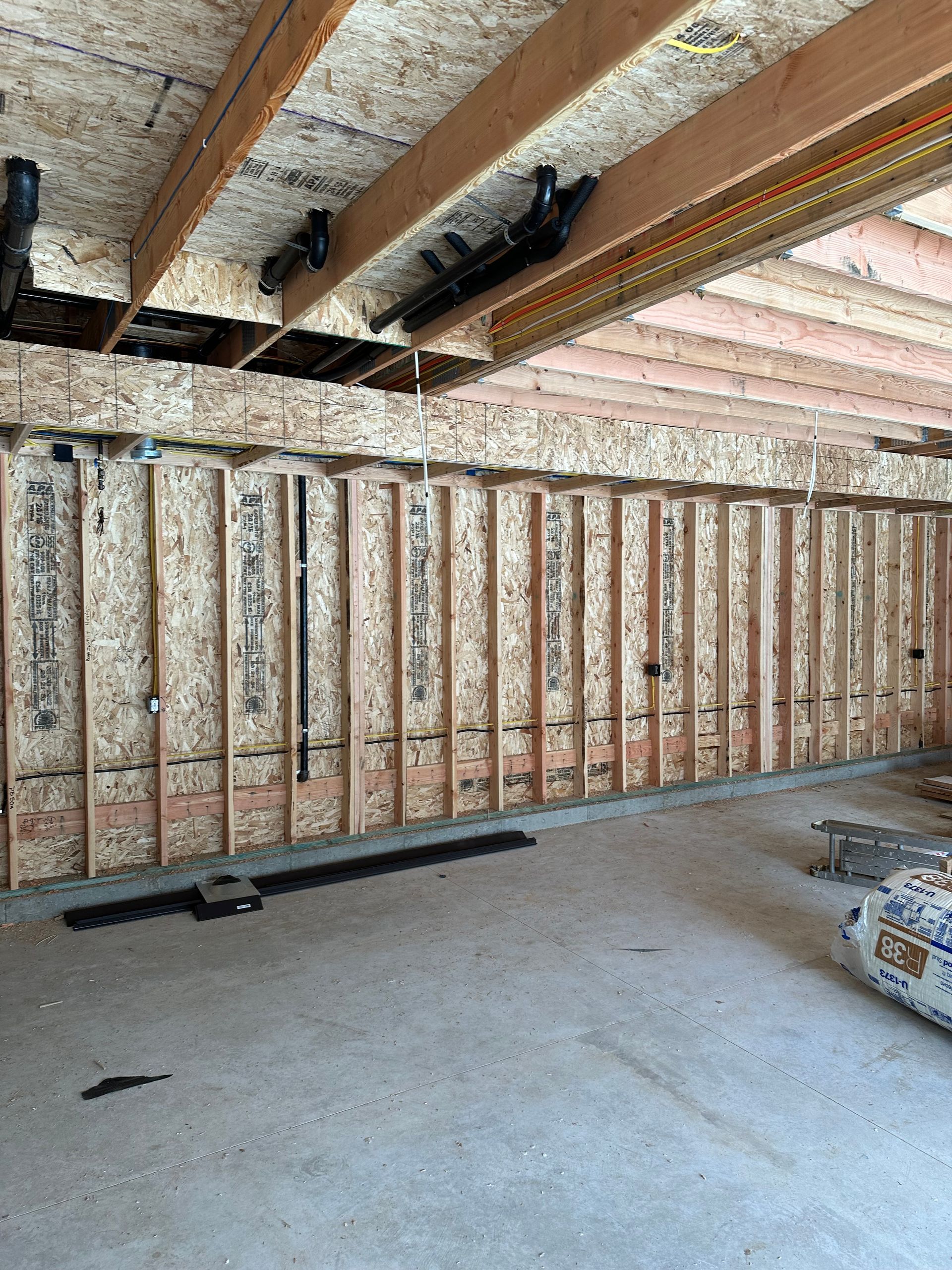 A room with a lot of wooden beams and a ceiling.