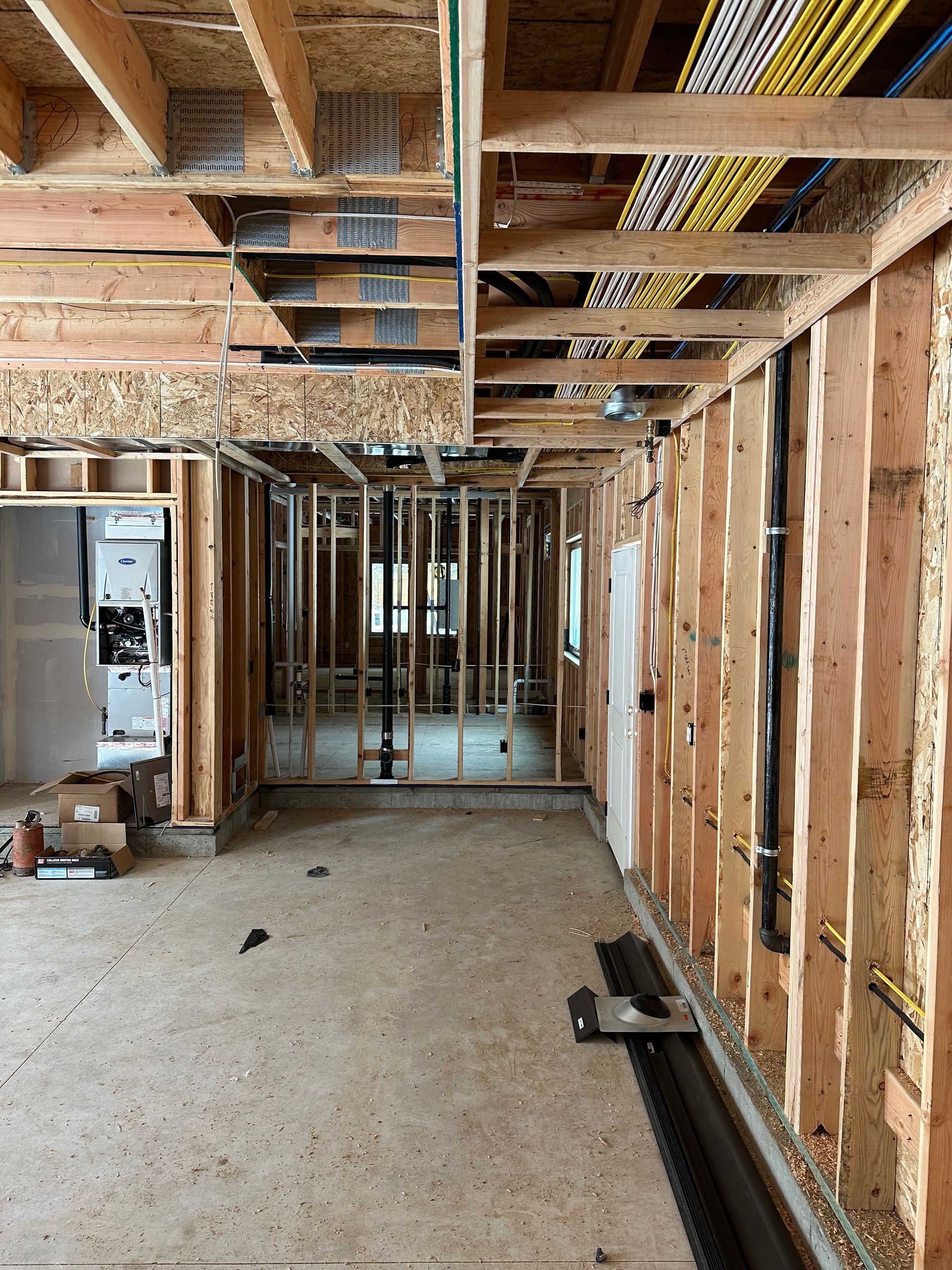 A room that is being built with a lot of wooden beams