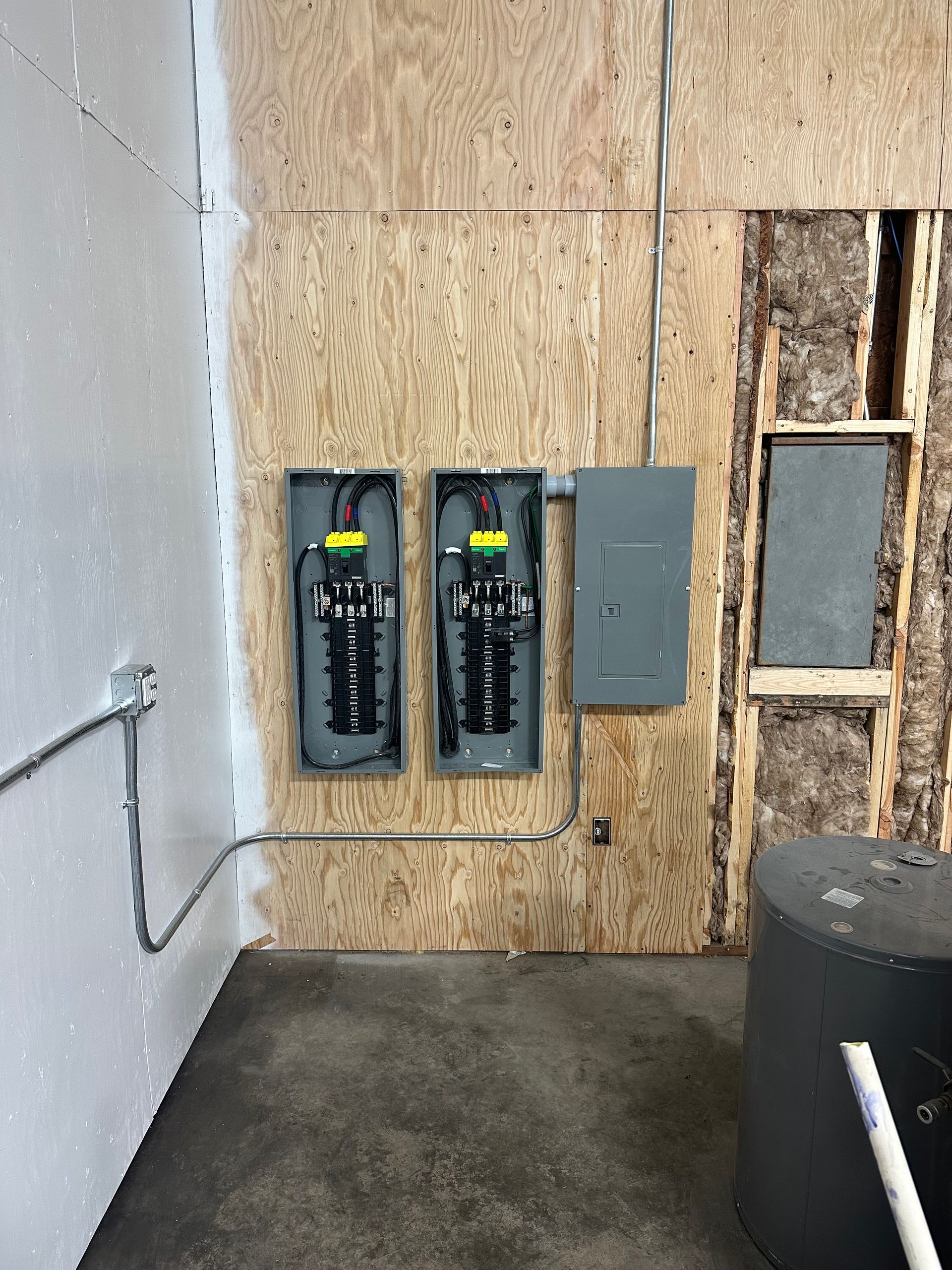 A room with two electrical panels on the wall.