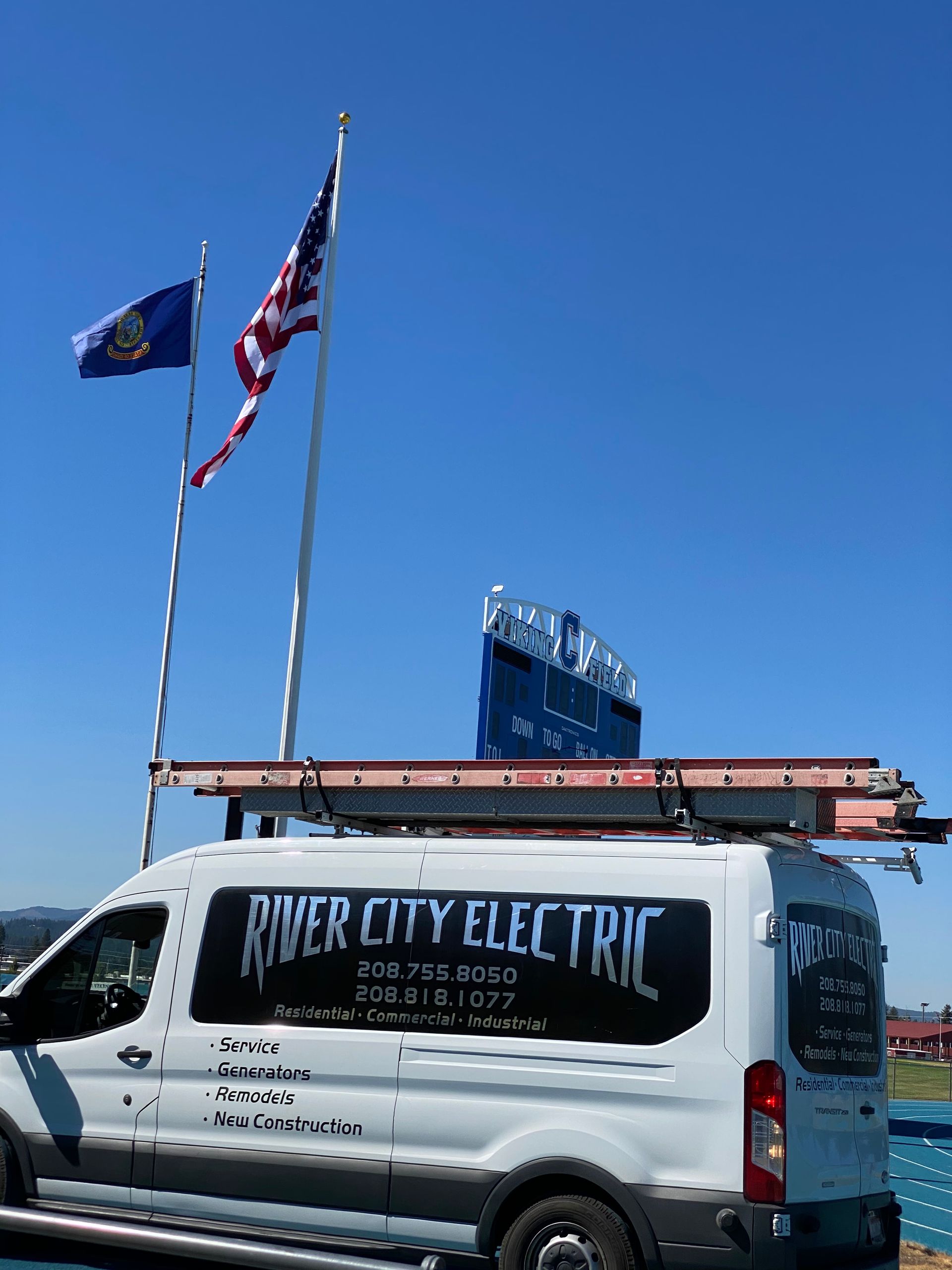 A white van with river city electric written on the side
