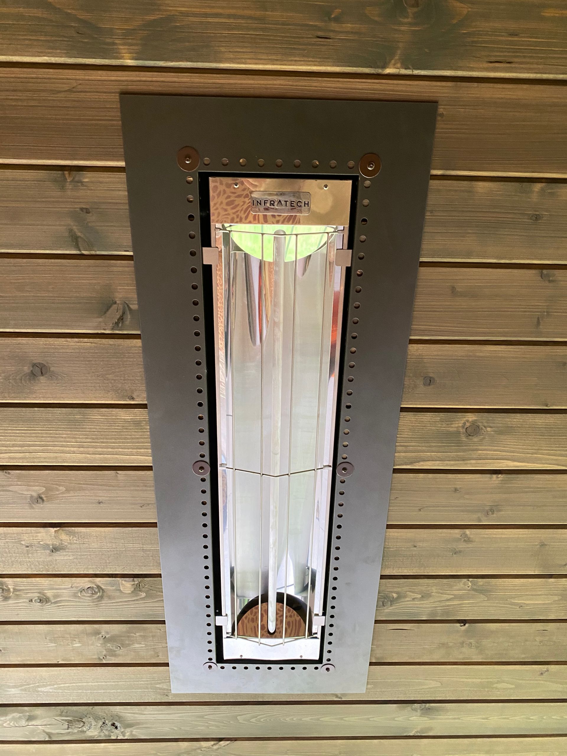 A light is hanging from the ceiling of a wooden building.